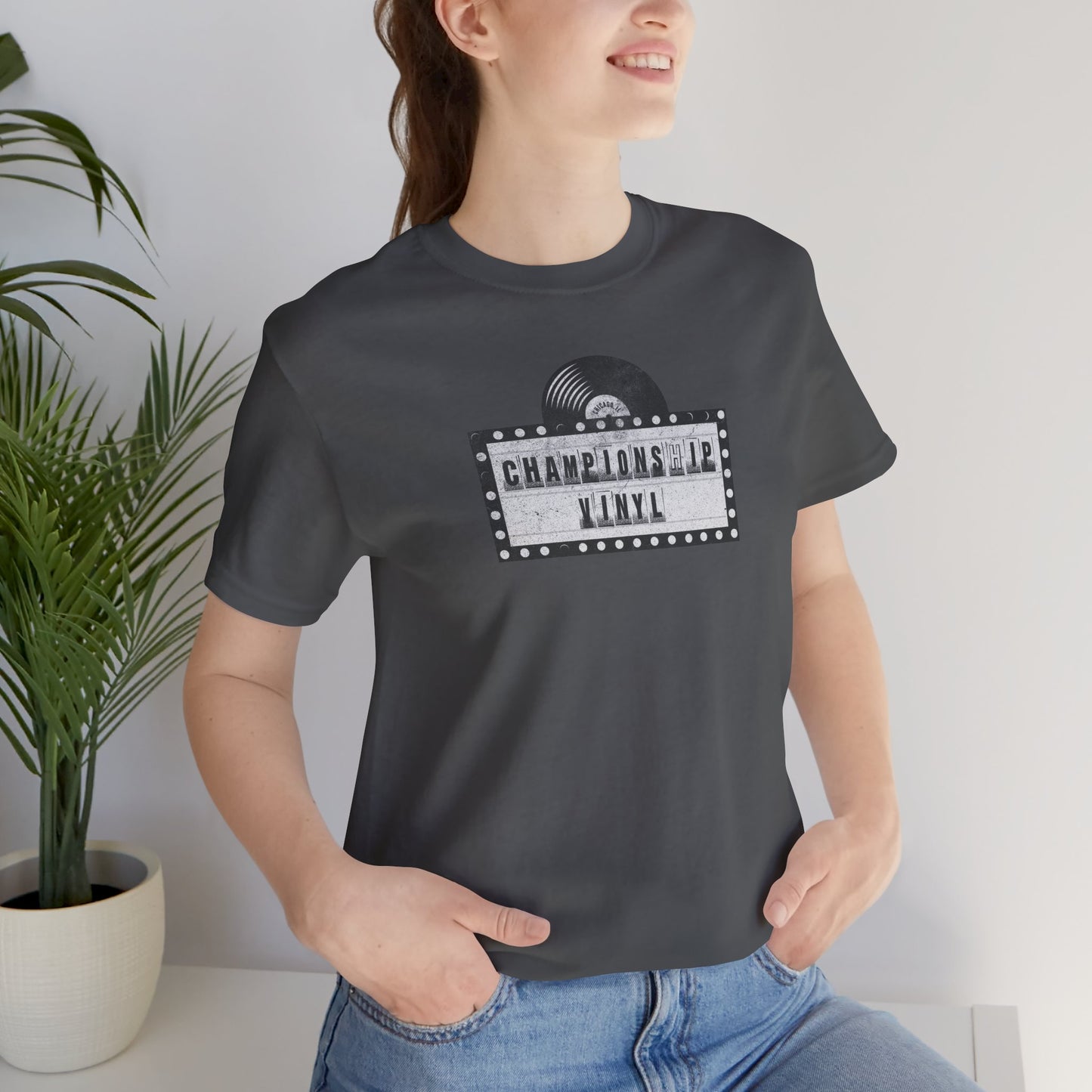 Female wearing Asphalt t-shirt featuring the CHAMPIONSHIP VINYL record store logo from movie High Fidelity in a vintage distressed style.