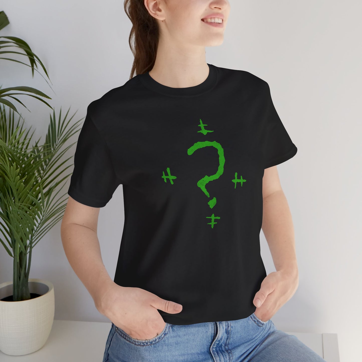 Woman wearing a black t-shirt featuring the Riddler Question Mark logo from the movie The Batman in vintage distressed style.