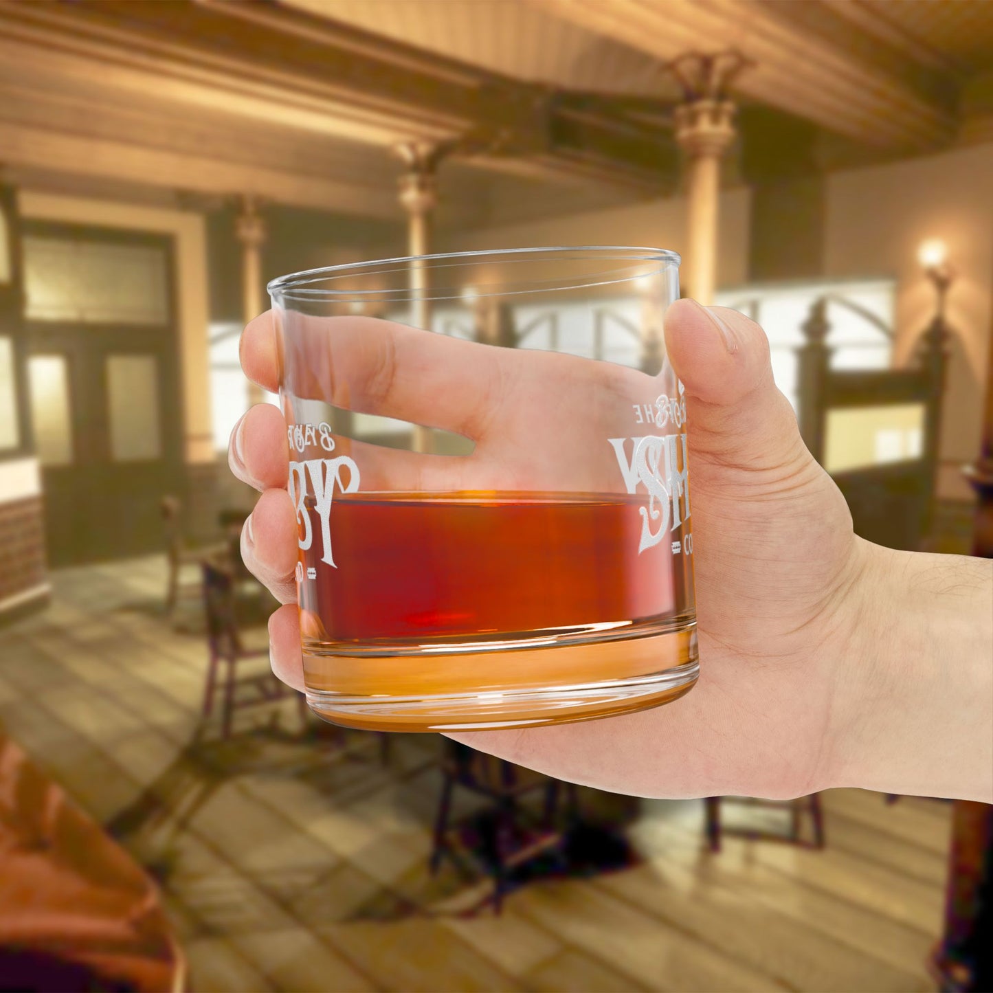 hand holding a half-filled 10 ounce Rocks Glass with Shelby Company LTD logo from Peaky Blinders printed on both sides