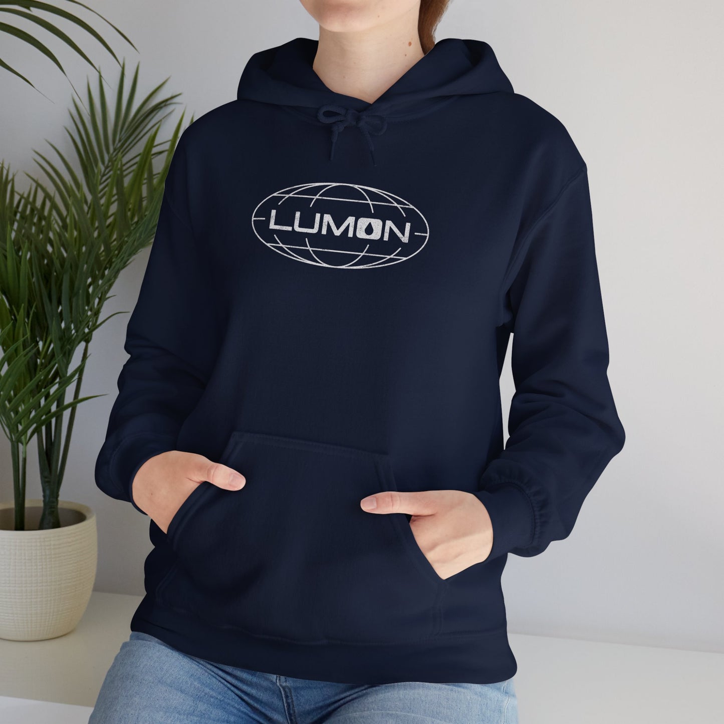 Woman model wearing a Navy Blue colored Soft Unisex Heavy Blend Hooded Sweatshirt featuring the fictional Lumon Industries logo from the Apple TV show Severance.