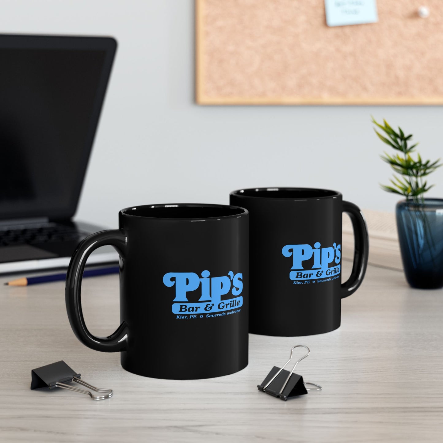 2 Black Ceramic Mugs (11 oz) on a desk featuring the Pips Bar and Grill logo from the Apple TV show Severance printed on both sides in Lumon Industries blue, sold by ScriptedBrand.