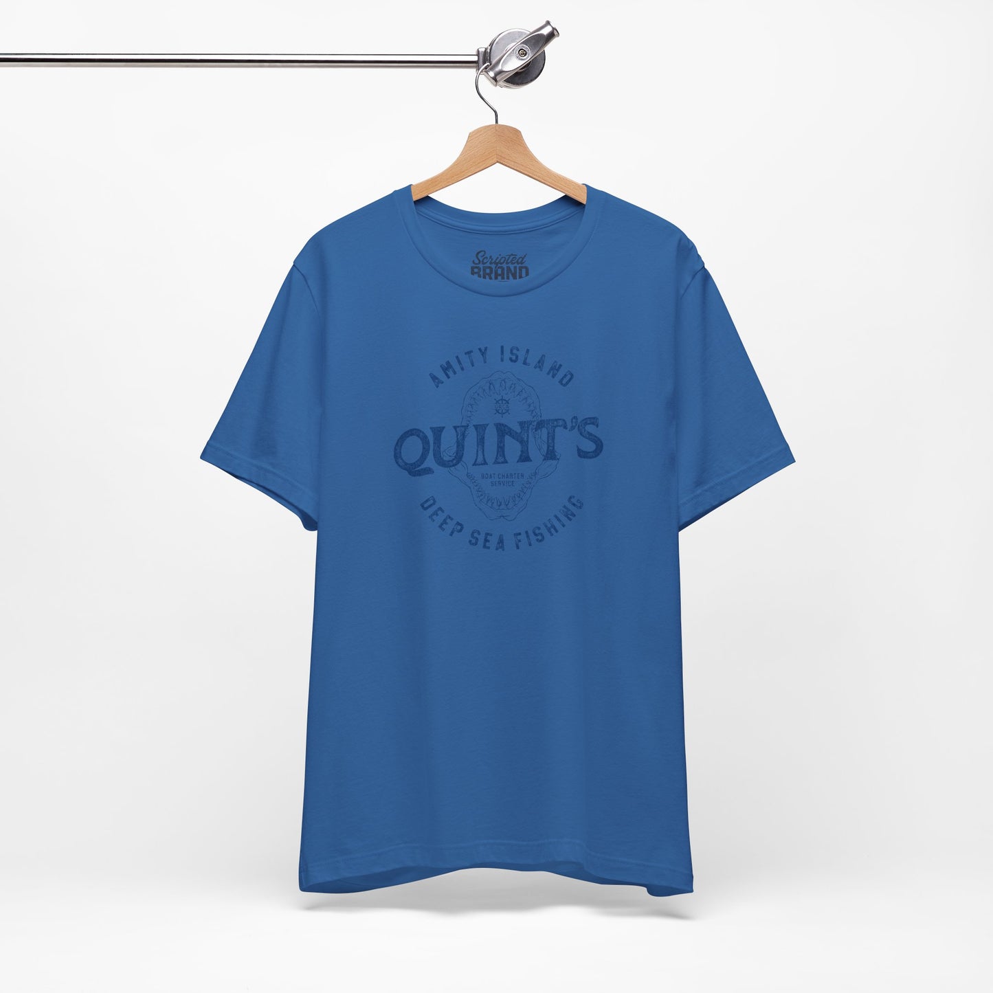 Columbia Blue colored Soft short-sleeve t-shirt on a hanger featuring the Quint's Deep Sea Fishing Boat Charters logo graphic inspired by the movie Jaws in a vintage distressed ink-stamped worn-in style.