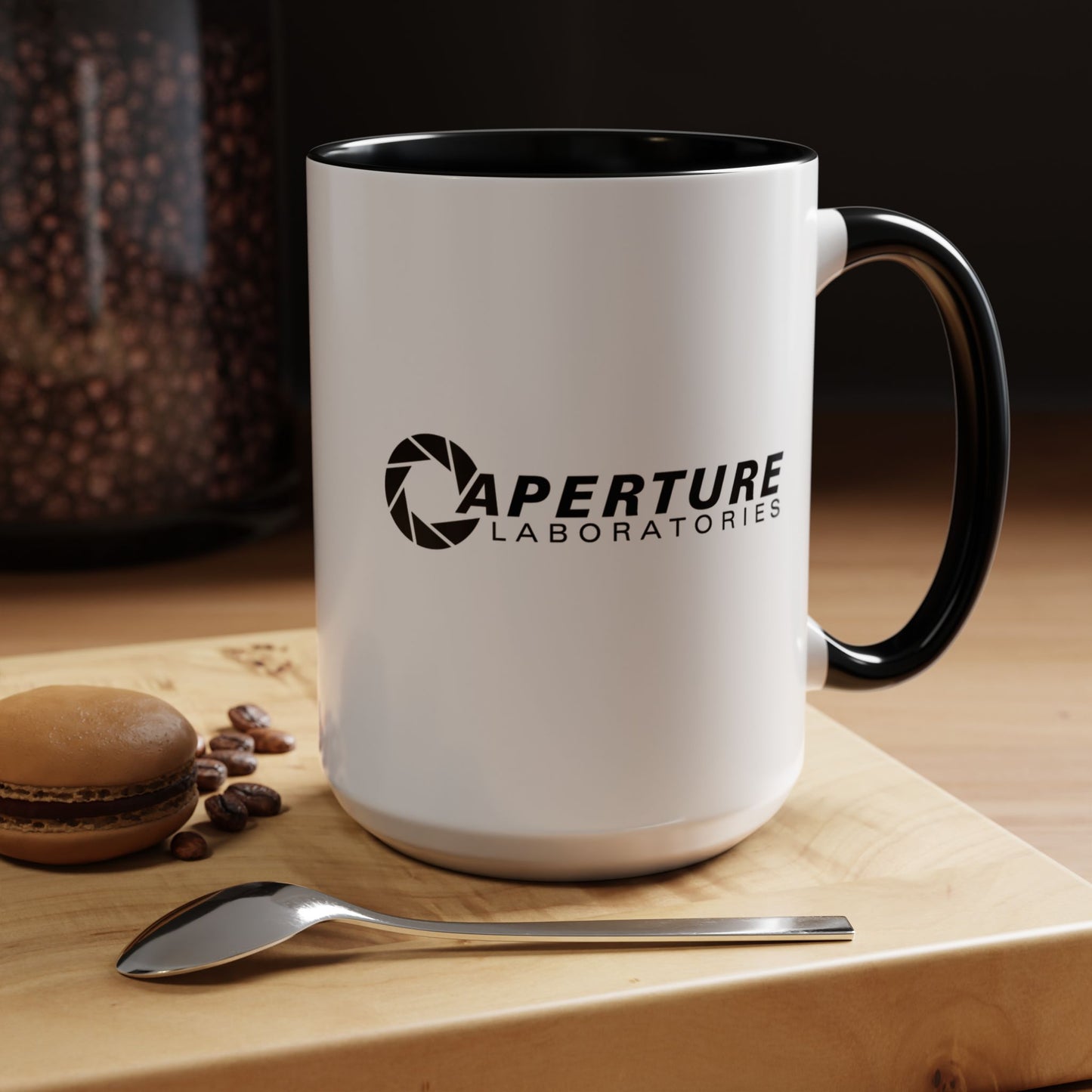 Front kitchen view of a 15 oz white Ceramic Accent Mug with the black Aperture Laboratories logo from the video game Portal on both sides. Handle and interior are colored black.