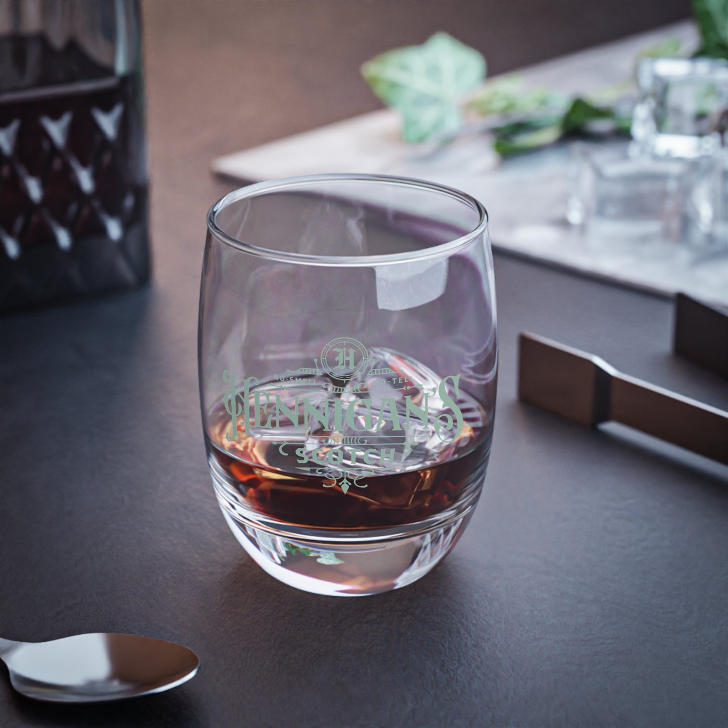 lifestyle view of a 6 ounce Whiskey Glass with Hennigan's Scotch logo designed by ScriptedBrand from the TV show Seinfeld.