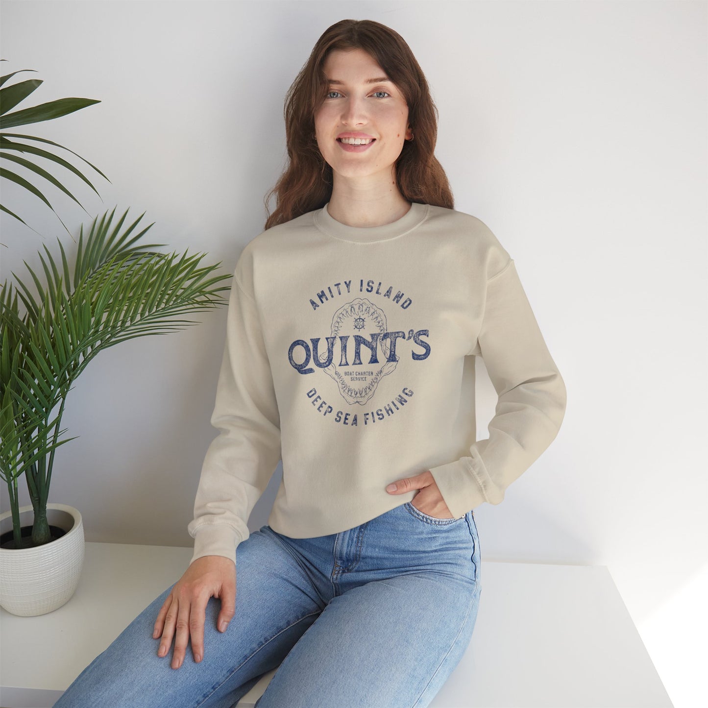 female wearing sand colored sweatshirt with Quint's Deep Sea Fishing logo from the movie Jaws in vintage distressed style.