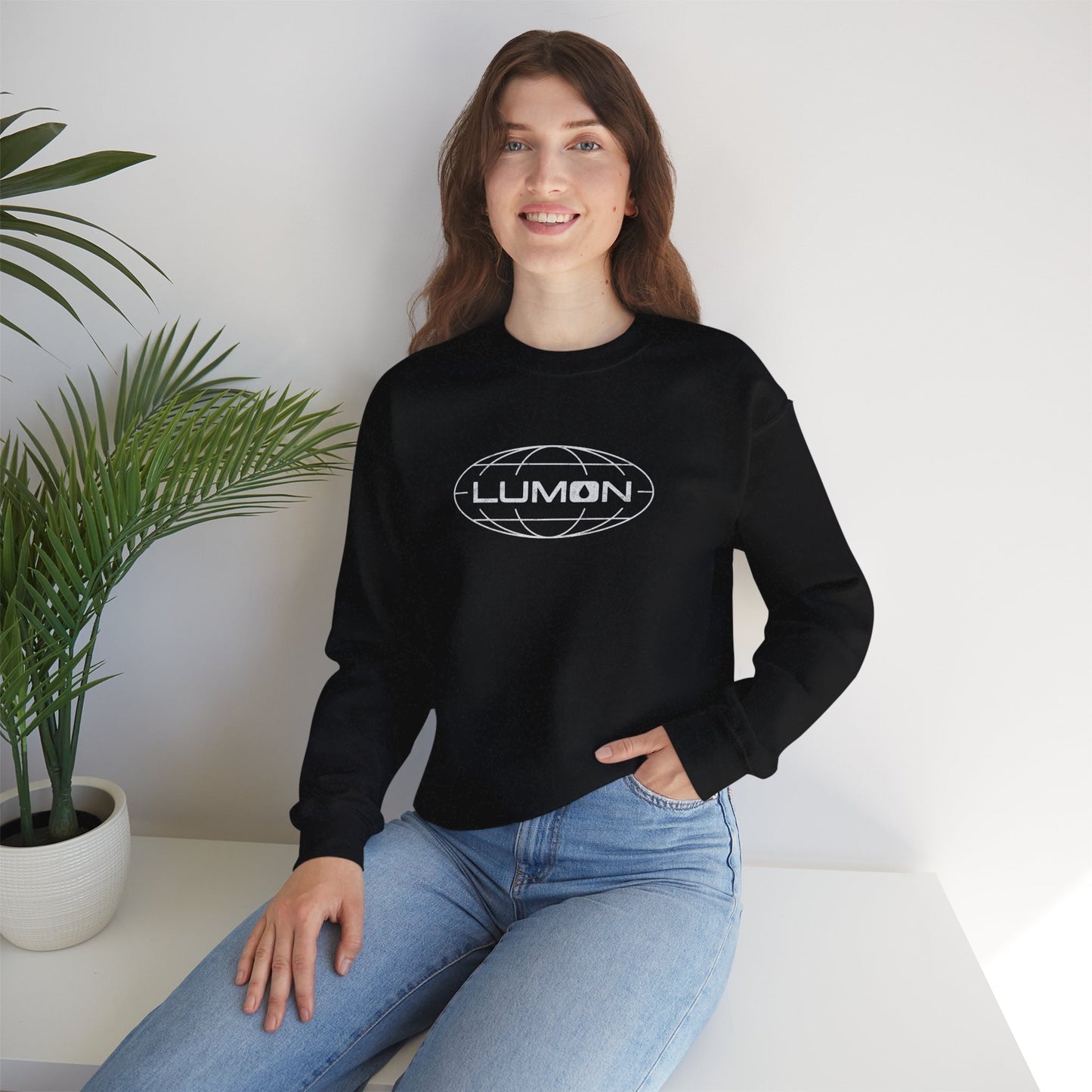Female model wearing a black Soft Gildan 18000 crew neck sweatshirt featuring the Lumon Industries logo from the Apple TV show Severance in a vintage distressed style.