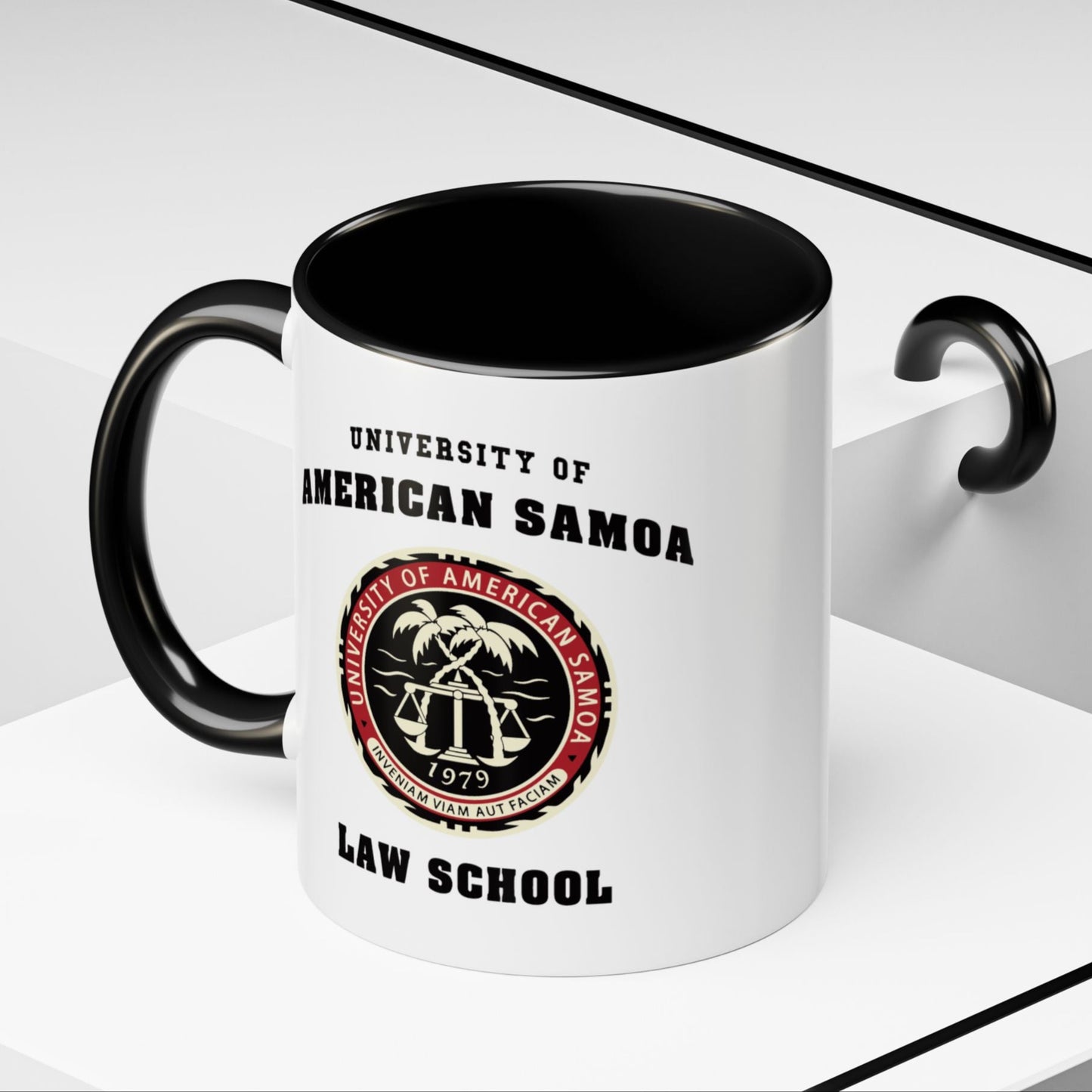Angled view of 11 oz Ceramic mug with black handle featuring University of American Samoa Law School logo from Better Call Saul on both sides.