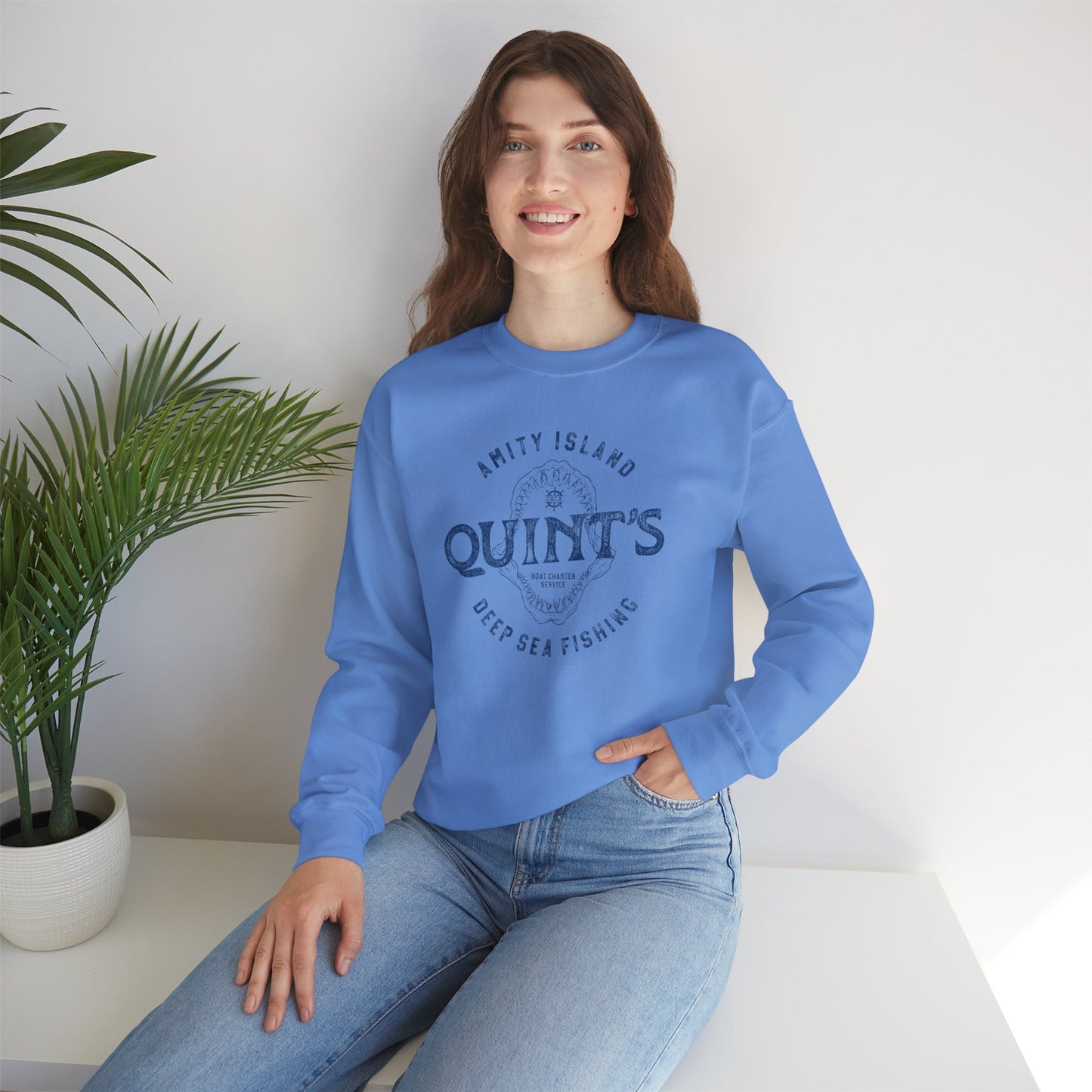 female wearing blue colored sweatshirt with Quint's Deep Sea Fishing logo from the movie Jaws in vintage distressed style.