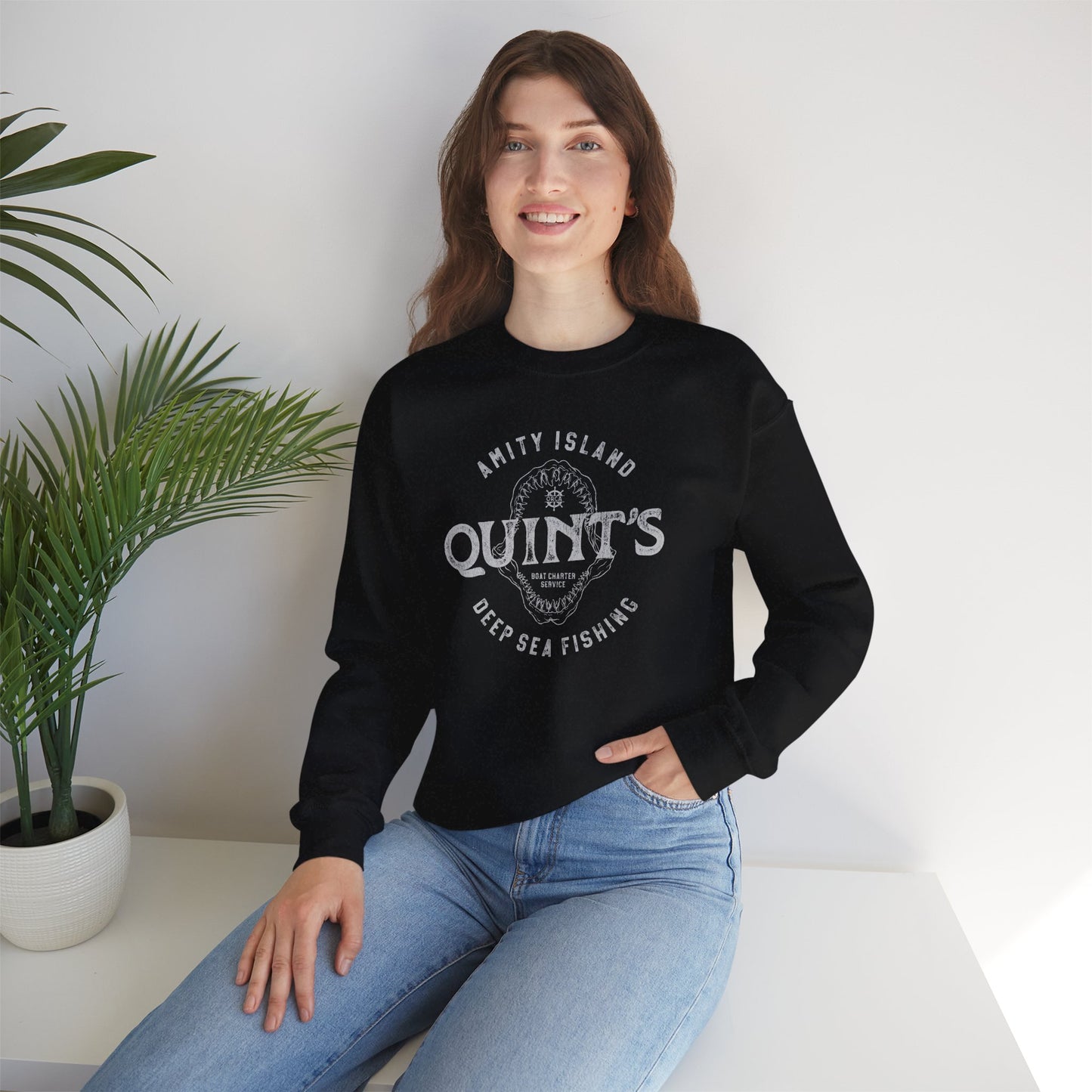 female wearing black colored sweatshirt with Quint's Deep Sea Fishing logo from the movie Jaws in vintage distressed style.