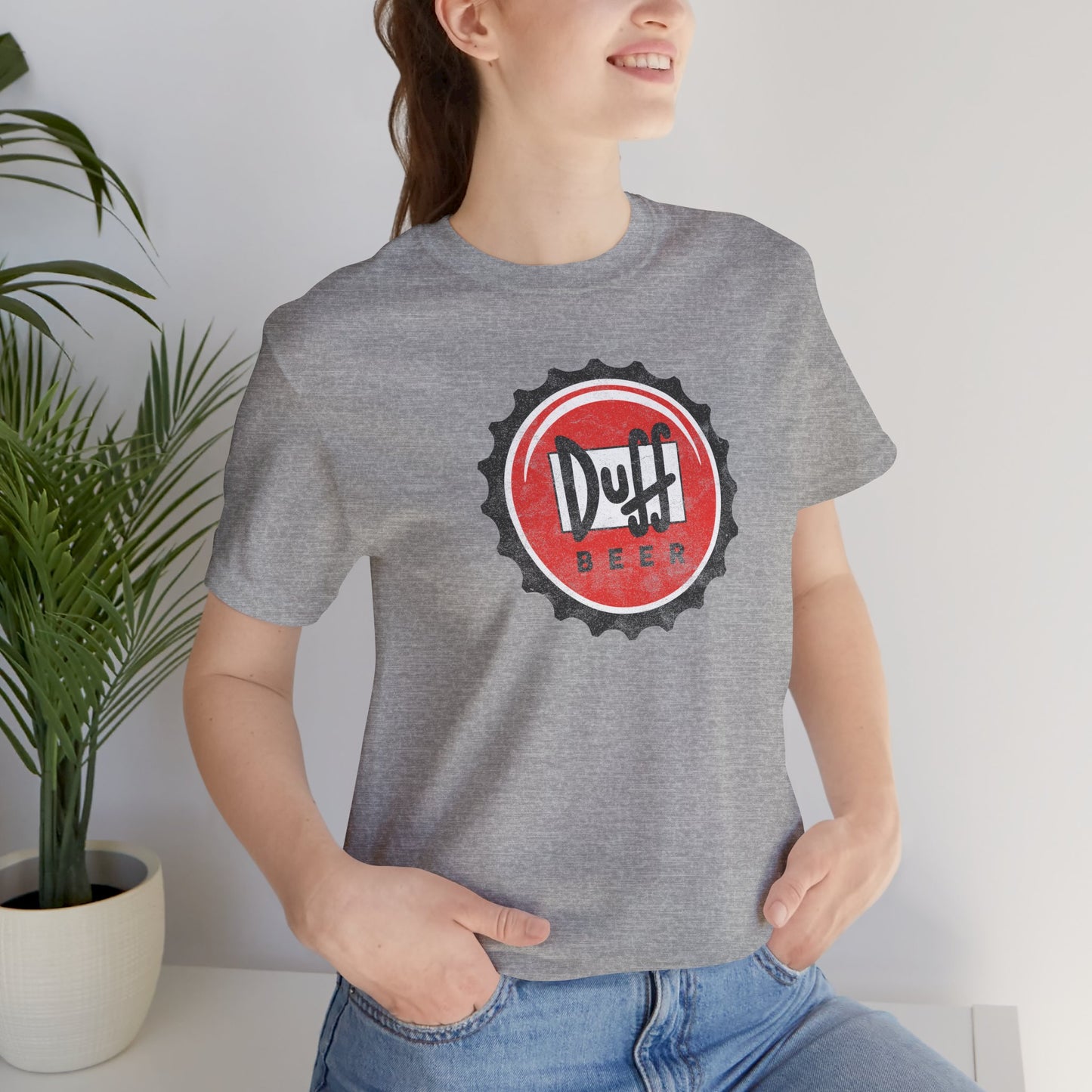 Woman wearing Athletic heather gray t-shirt featuring the Duff Beer bottle cap logo from the TV Show The Simpsons in vintage distressed style.