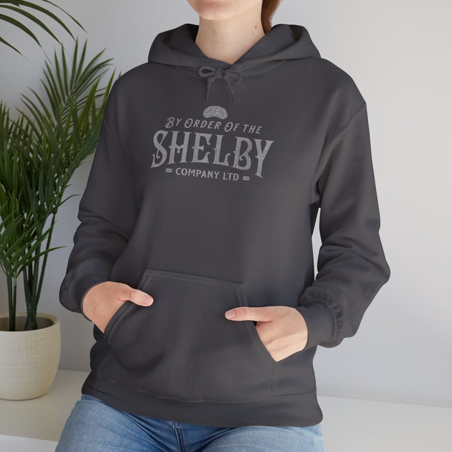 Female wearing a charcoal Shelby Company Ltd hoodie with vintage logo from Peaky Blinders, featuring flat cap and razor blades.