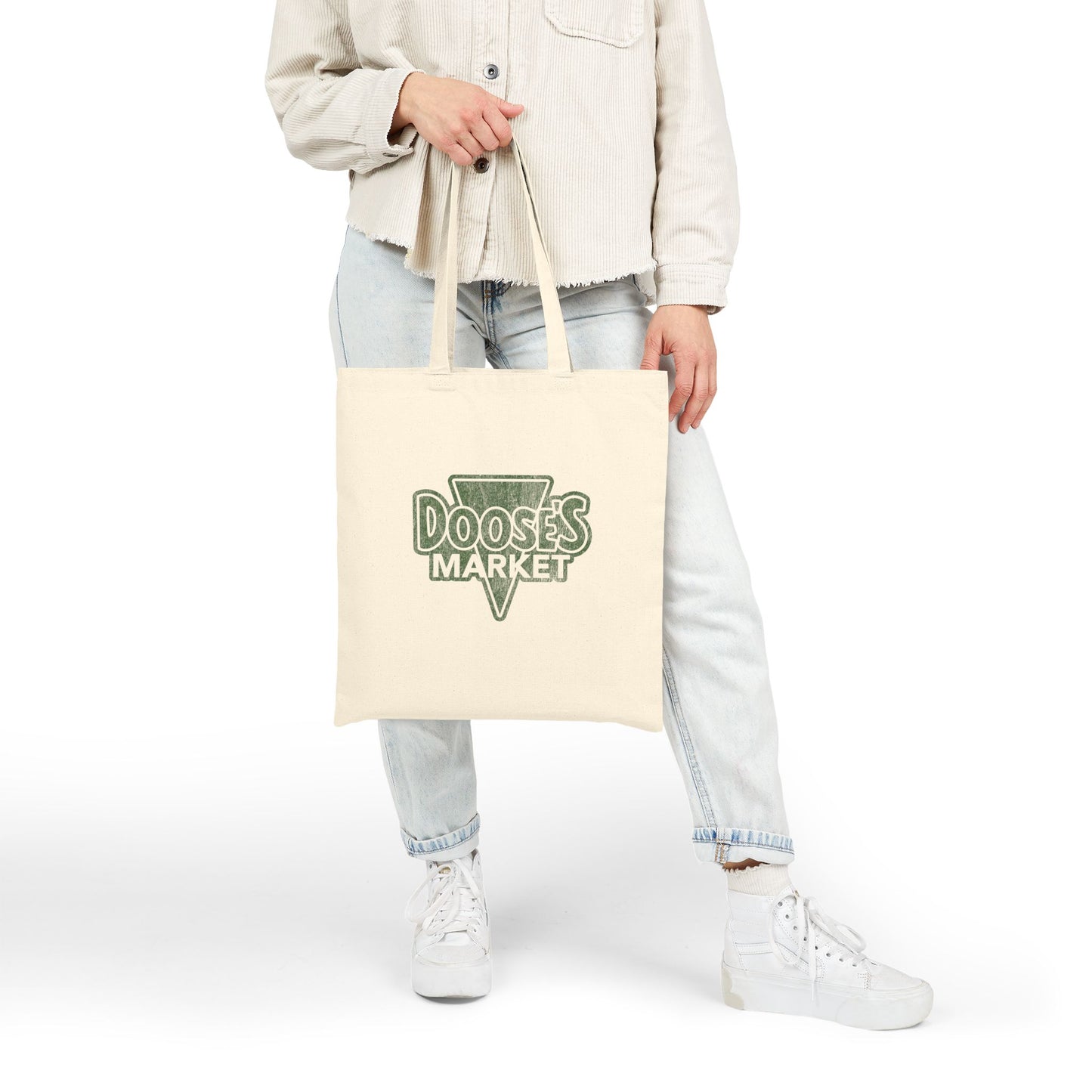 Person holding cotton canvas tote bag with vintage green Doose’s Market logo on both sides, inspired by Gilmore Girls.