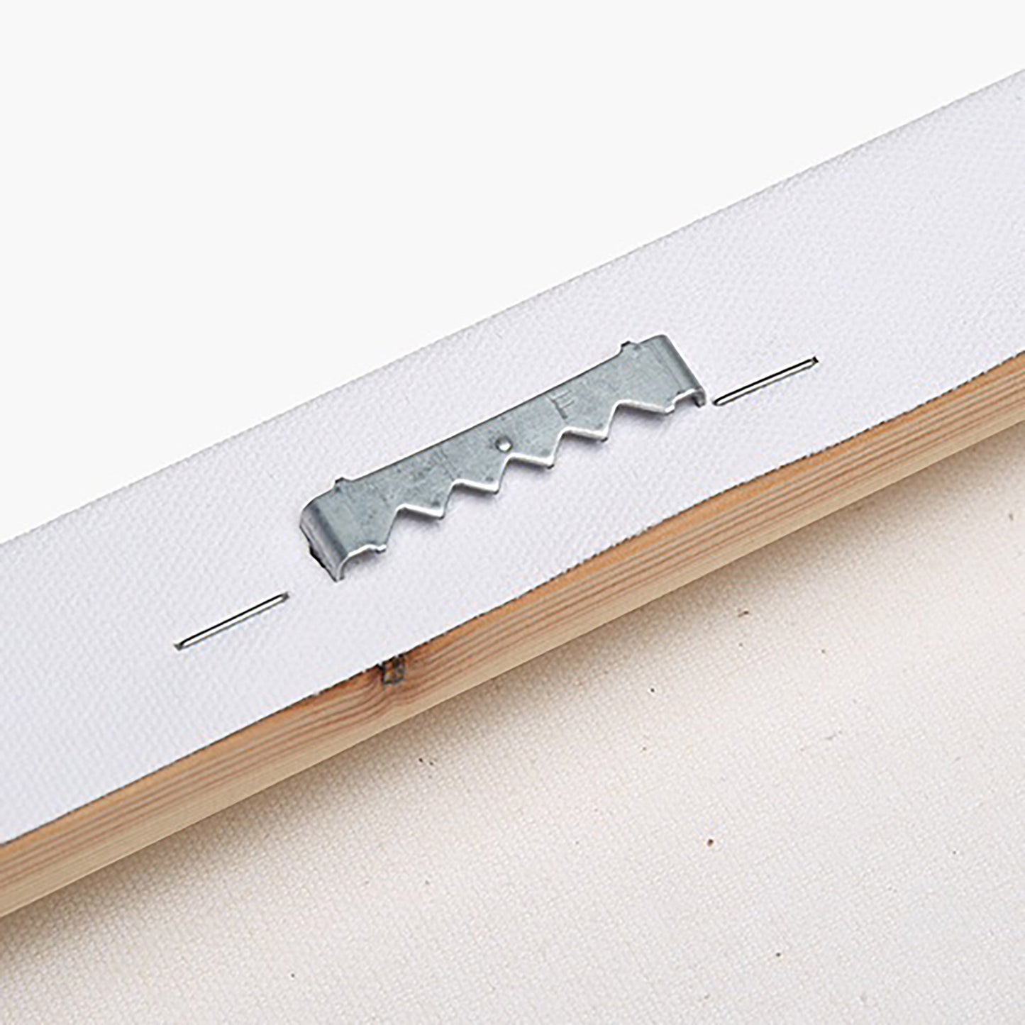 closeup of back hanging tool for stretched canvas on a wooden frame with white background