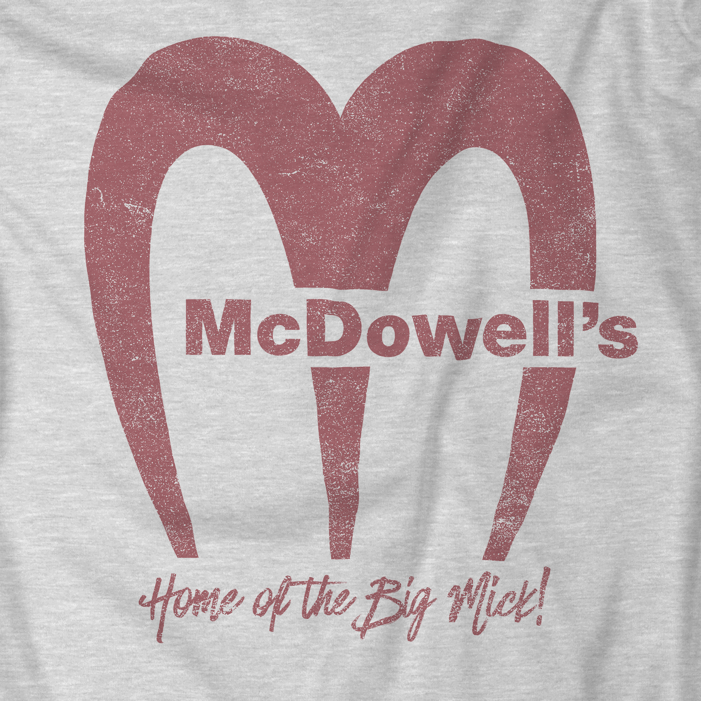 Closeup of Heather gray t-shirt featuring the McDowells logo from the movie Coming to America in a vintage distressed style.