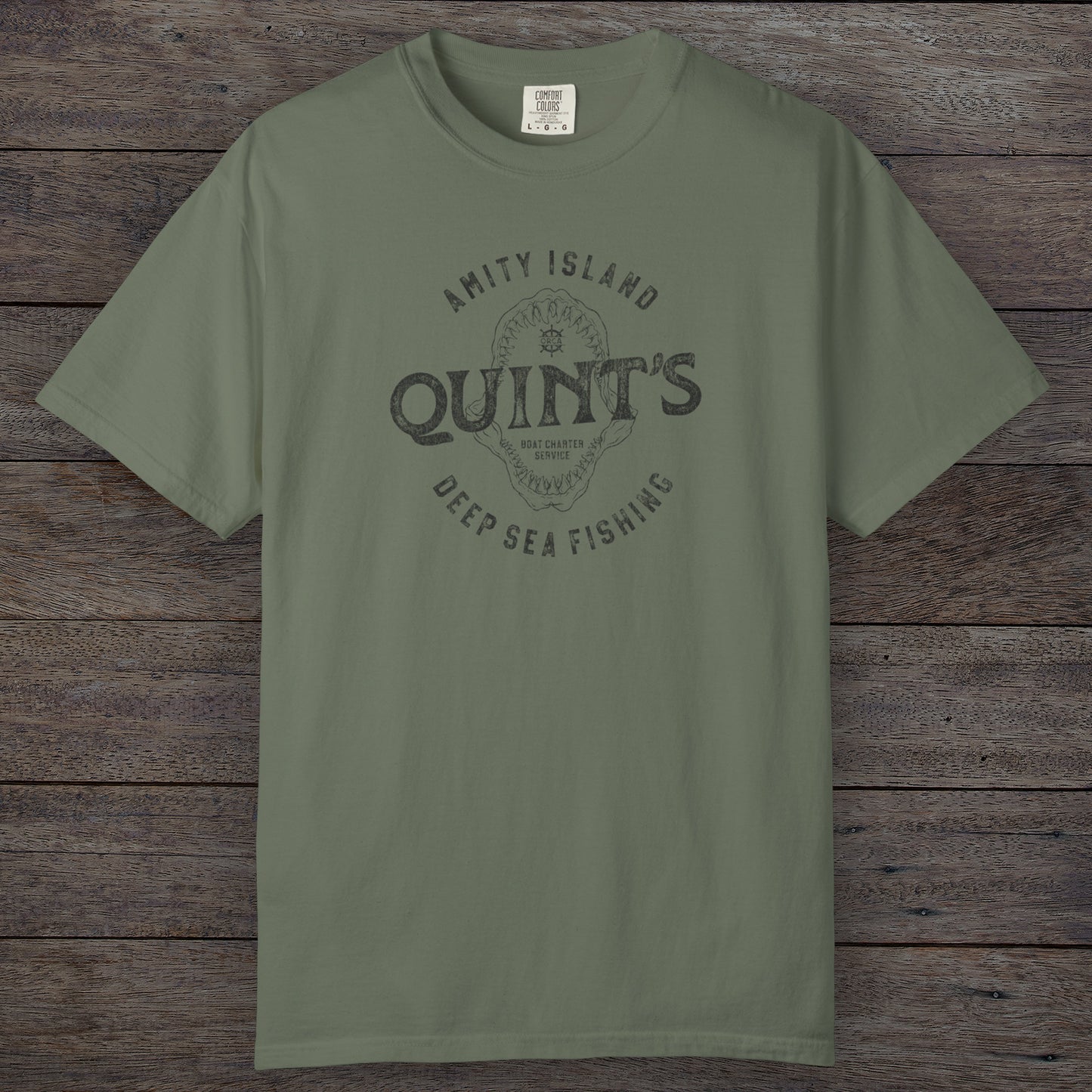 Moss Comfort Colors t-shirt with vintage Quint’s Deep Sea Fishing logo from Jaws, featuring shark graphic, distressed style.