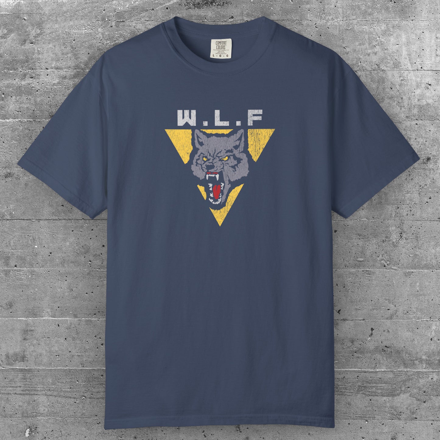 Midnight blue t-shirt with distressed WLF logo from The Last of Us, featuring a snarling wolf inside a yellow triangle.