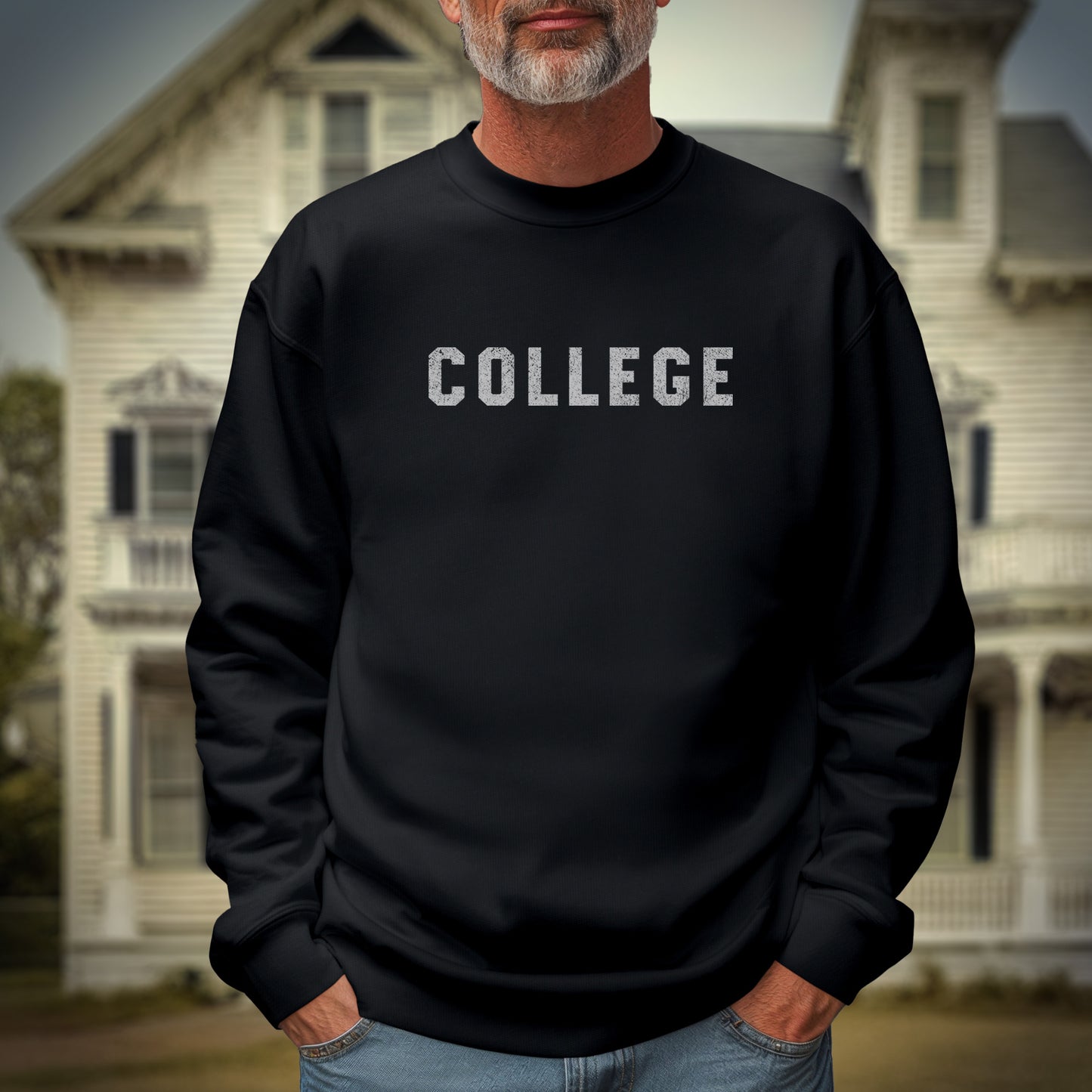 Male model wearing a black colored soft unisex Gildan 18000 sweatshirt with the word COLLEGE that John Belushi wore in the movie Animal House, in a vintage distressed ink-stamped worn-in style.