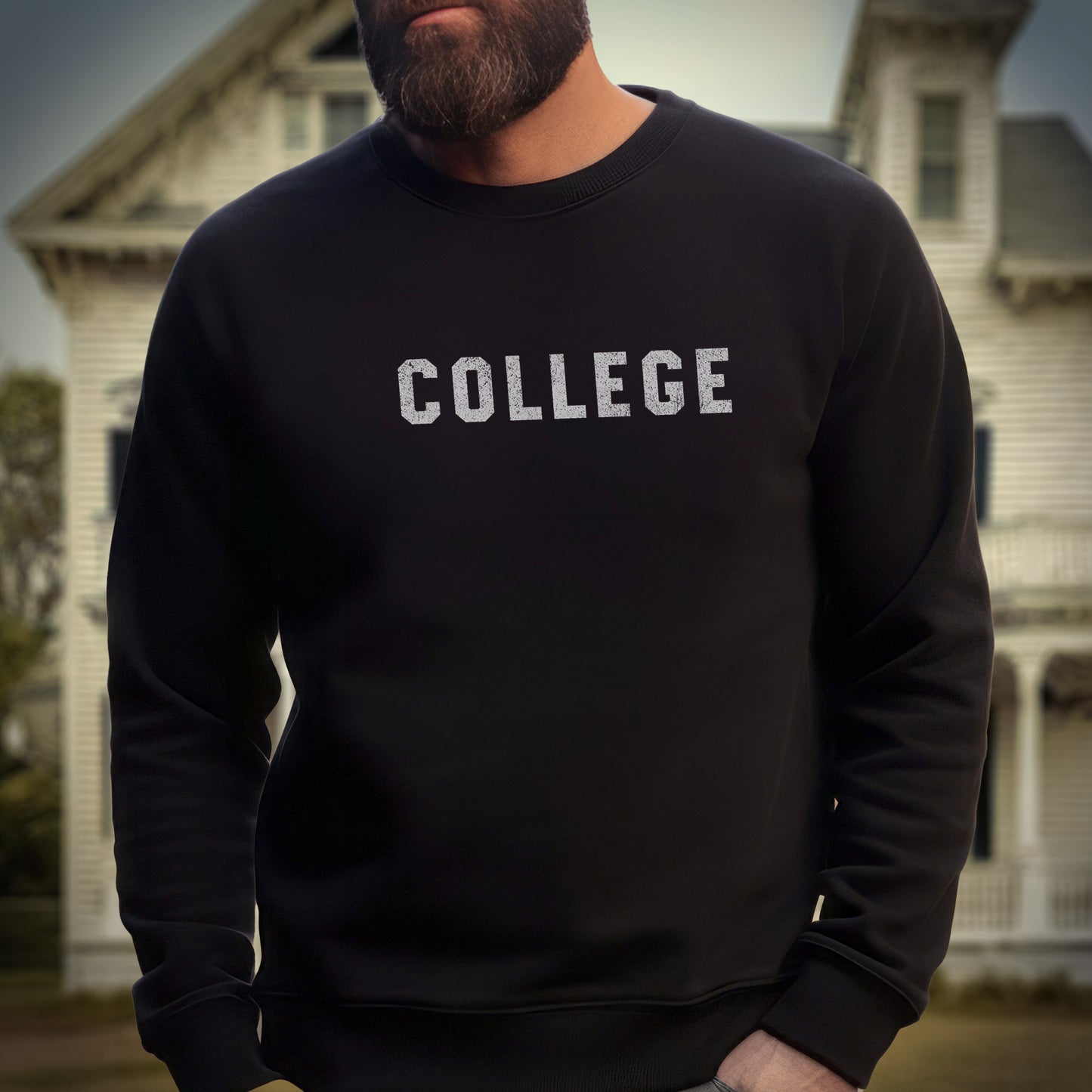 Model wearing a black unisex Gildan 18000 sweatshirt with the word COLLEGE that John Belushi wore in the movie Animal House, in a vintage distressed ink-stamped worn-in style, sold by ScriptedBrand.