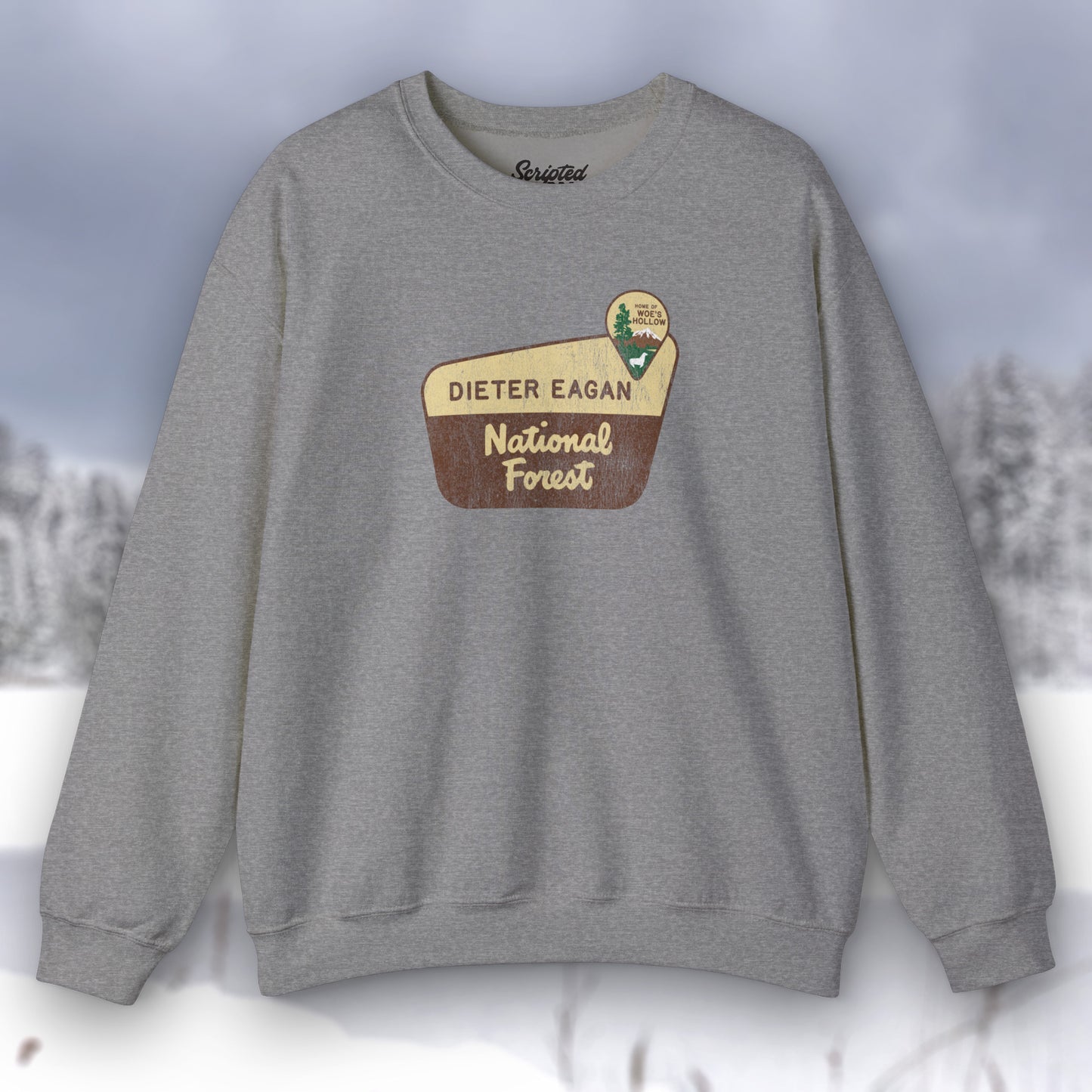 Front view of a dark gray heather Soft Unisex Gildan 18000 sweatshirt featuring a logo graphic of the Dieter Eagan National Forest sign designed by ScriptedBrand, inspired by the TV show Severance in a vintage distressed style.