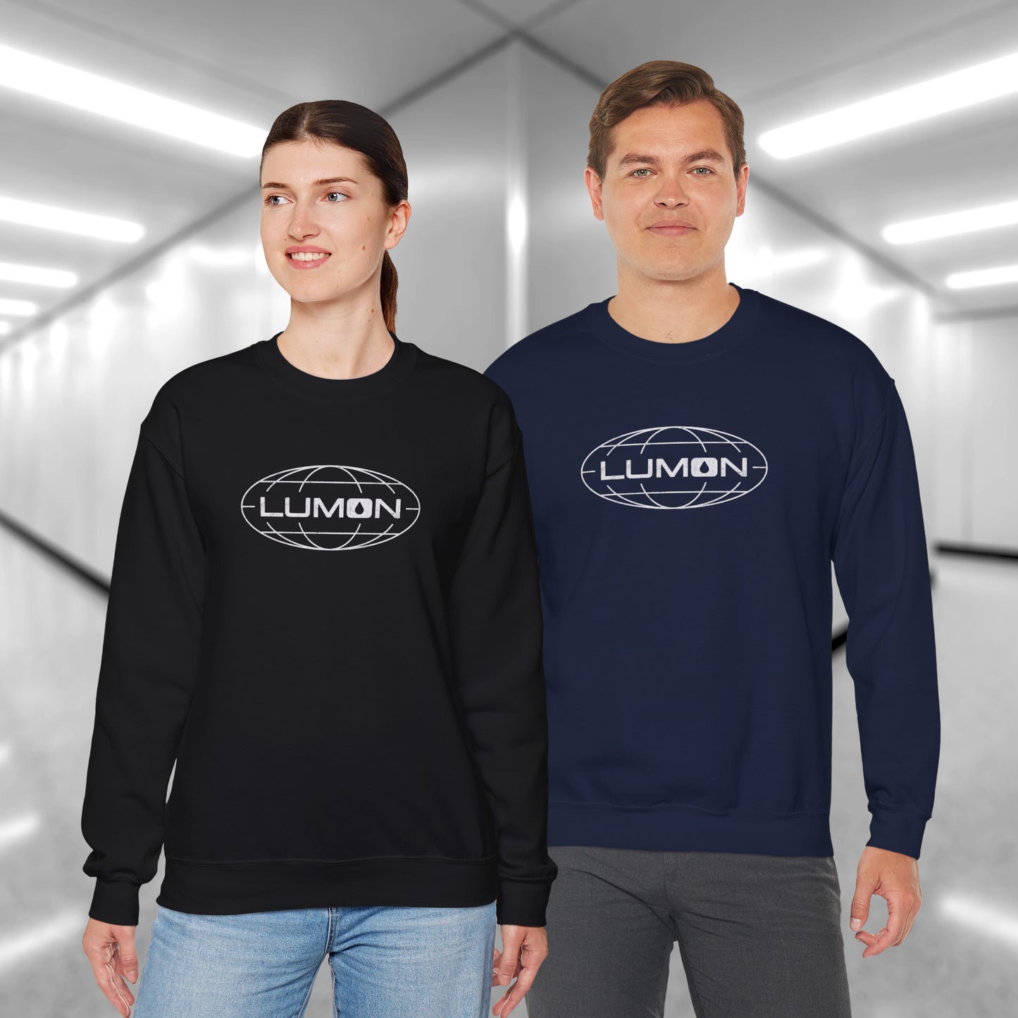 2 models wearing black and navy blue Gildan 18000 crew neck sweatshirts featuring the Lumon Industries logo from the Apple TV show Severance in a vintage distressed style.