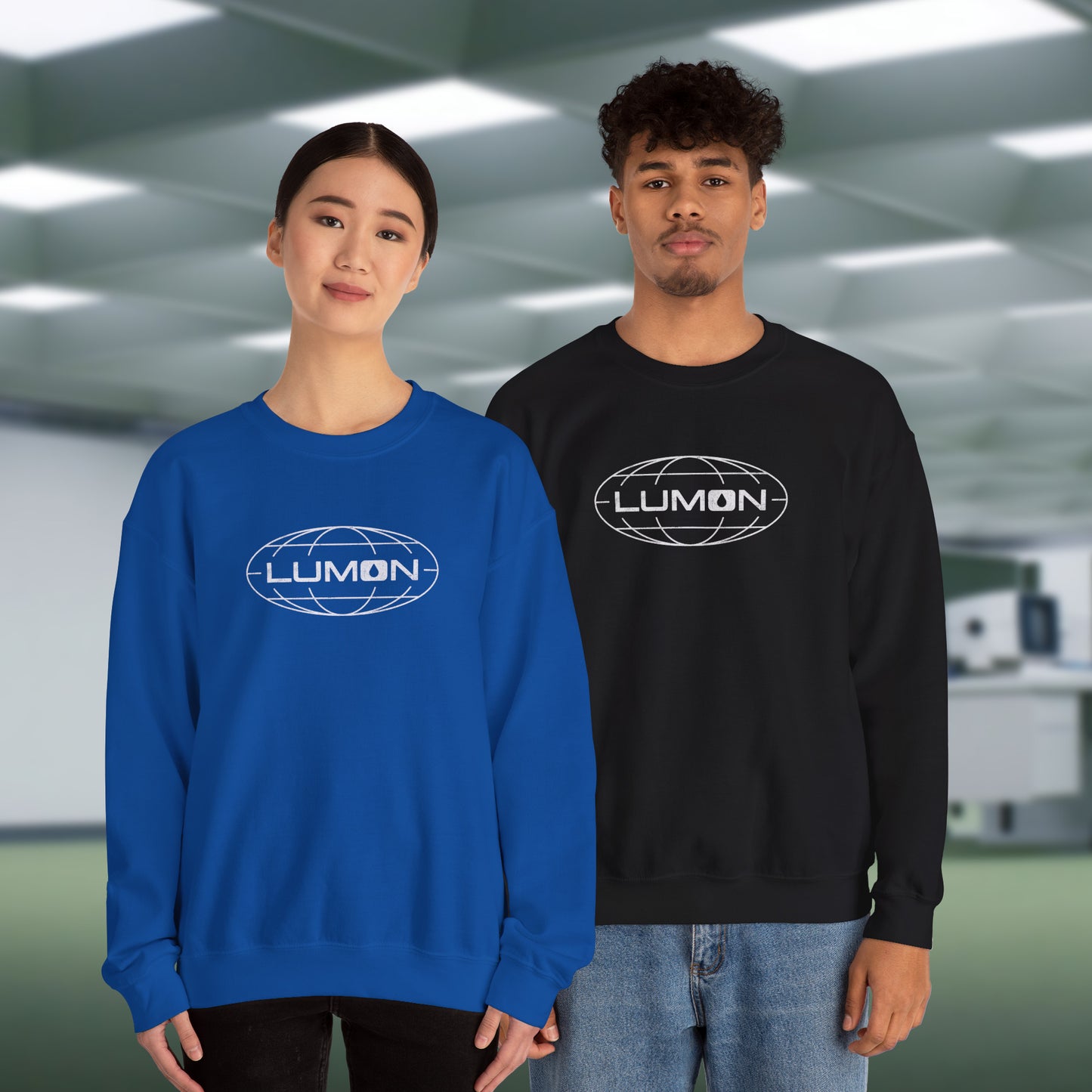 2 models wearing royal blue and black Gildan 18000 crew neck sweatshirts featuring the Lumon Industries logo from the Apple TV show Severance in a vintage distressed style.