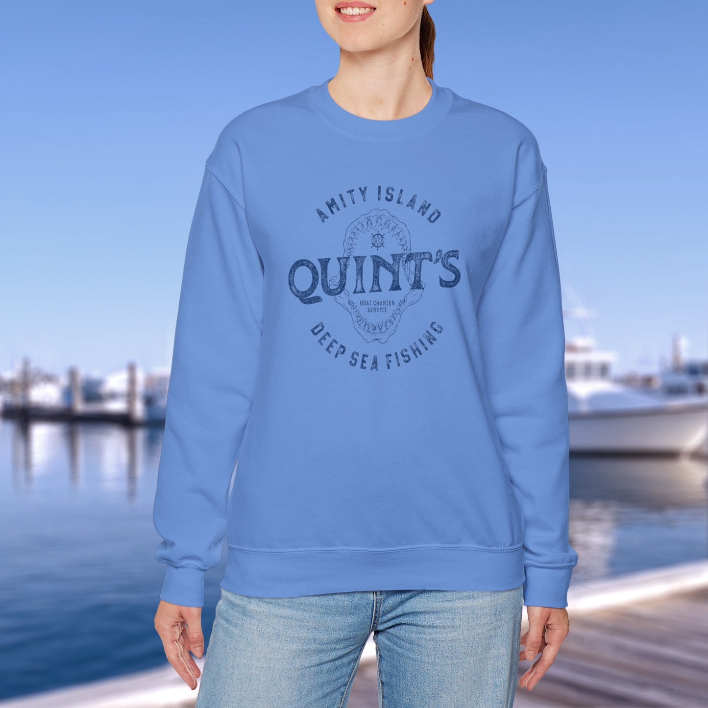 Model wearing blue colored sweatshirt with Quint's Deep Sea Fishing logo from the movie Jaws in vintage distressed style.