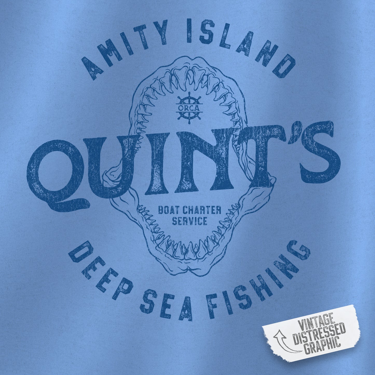 closeup view of blue colored sweatshirt with Quint's Deep Sea Fishing logo from the movie Jaws in vintage distressed style.