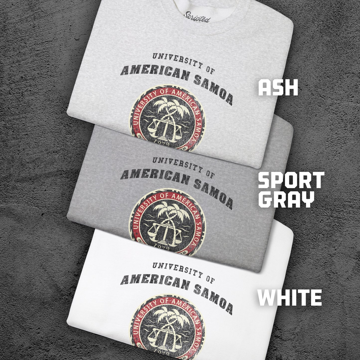 Three folded sweatshirts in ash, sport gray, and white with 'University of American Samoa' logo on a textured gray background.