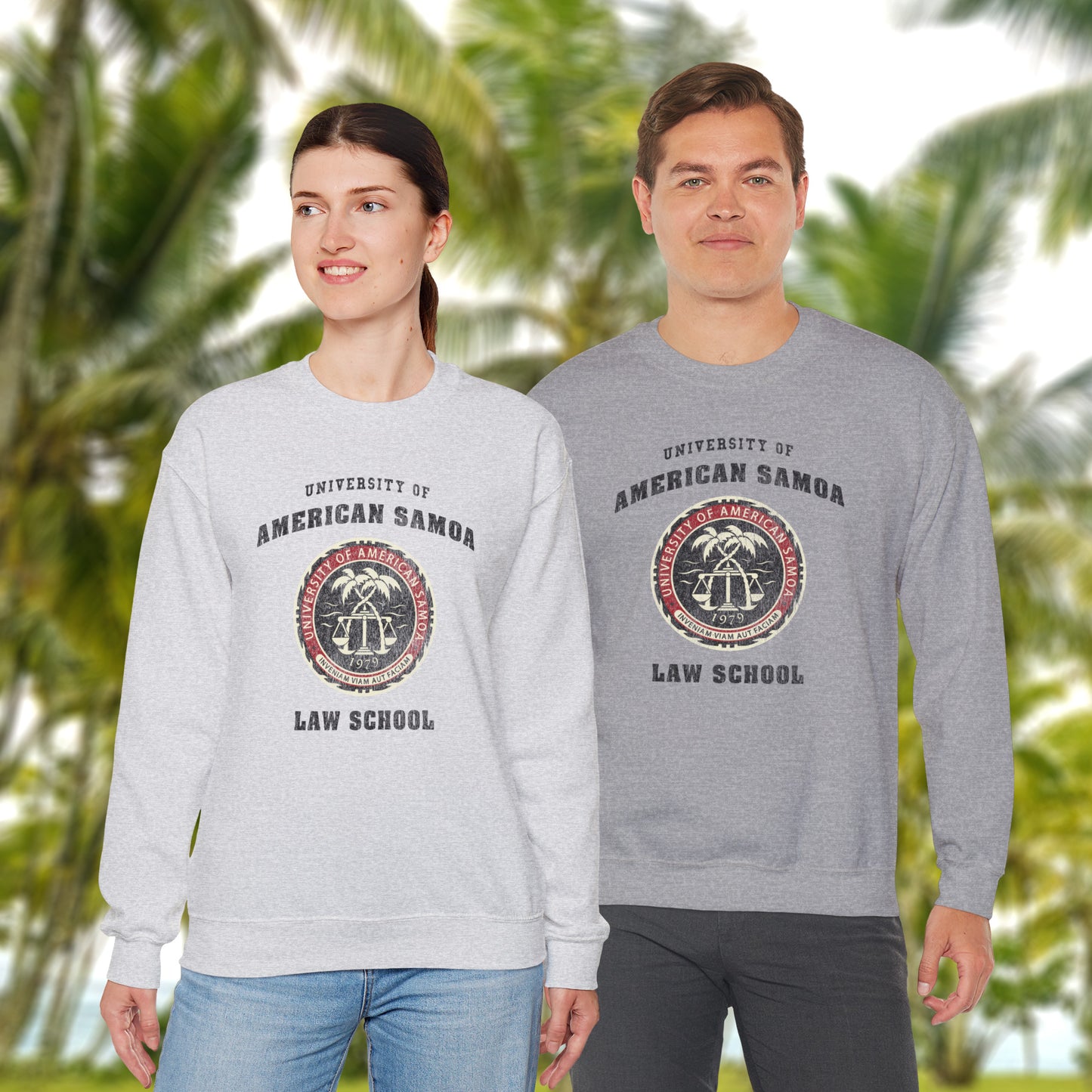 Two people wearing sweatshirts with 'University of American Samoa Law School' logo against a tropical background.