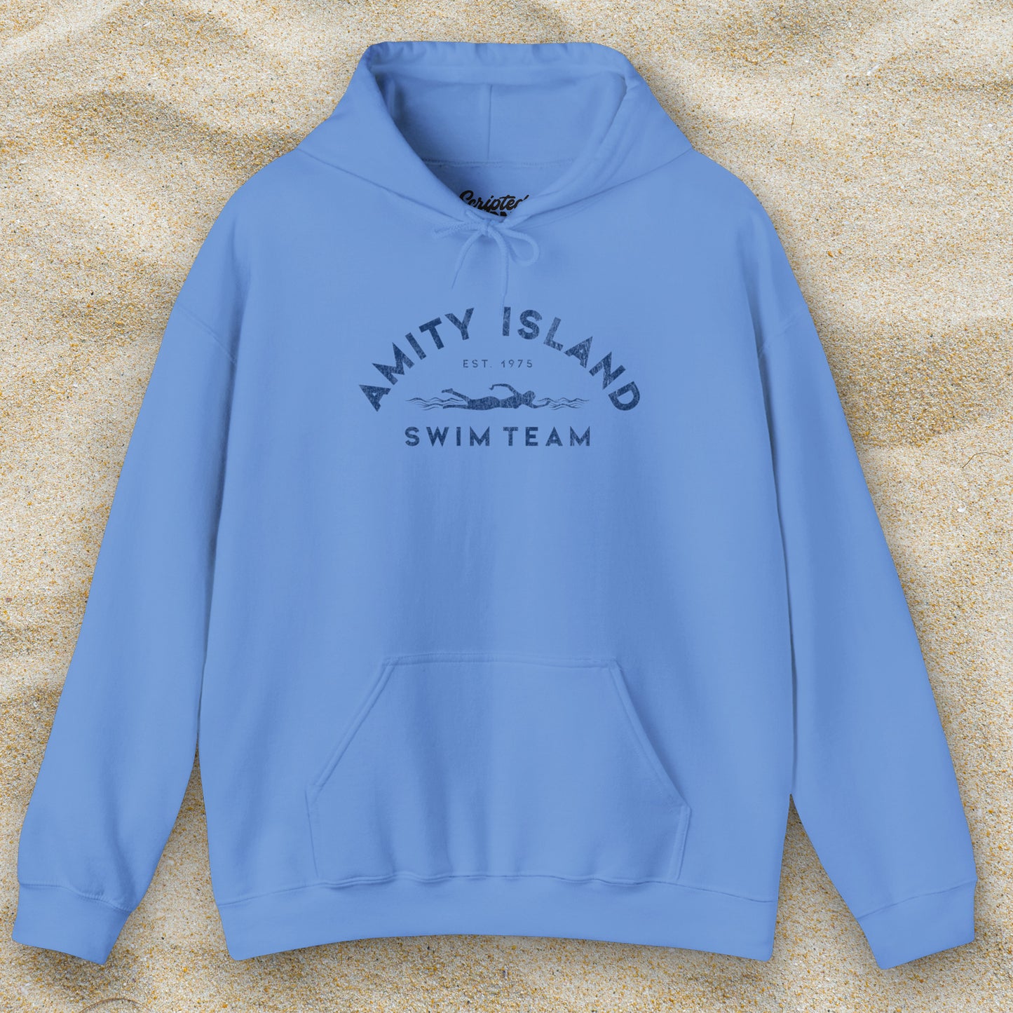 Front view of a Carolina Blue colored Soft Unisex Hoodie Heavy Blend Hooded Sweatshirt featuring an Amity Island Swim Team logo graphic, designed by ScriptedBrand, and inspired by the movie Jaws in a vintage distressed style.