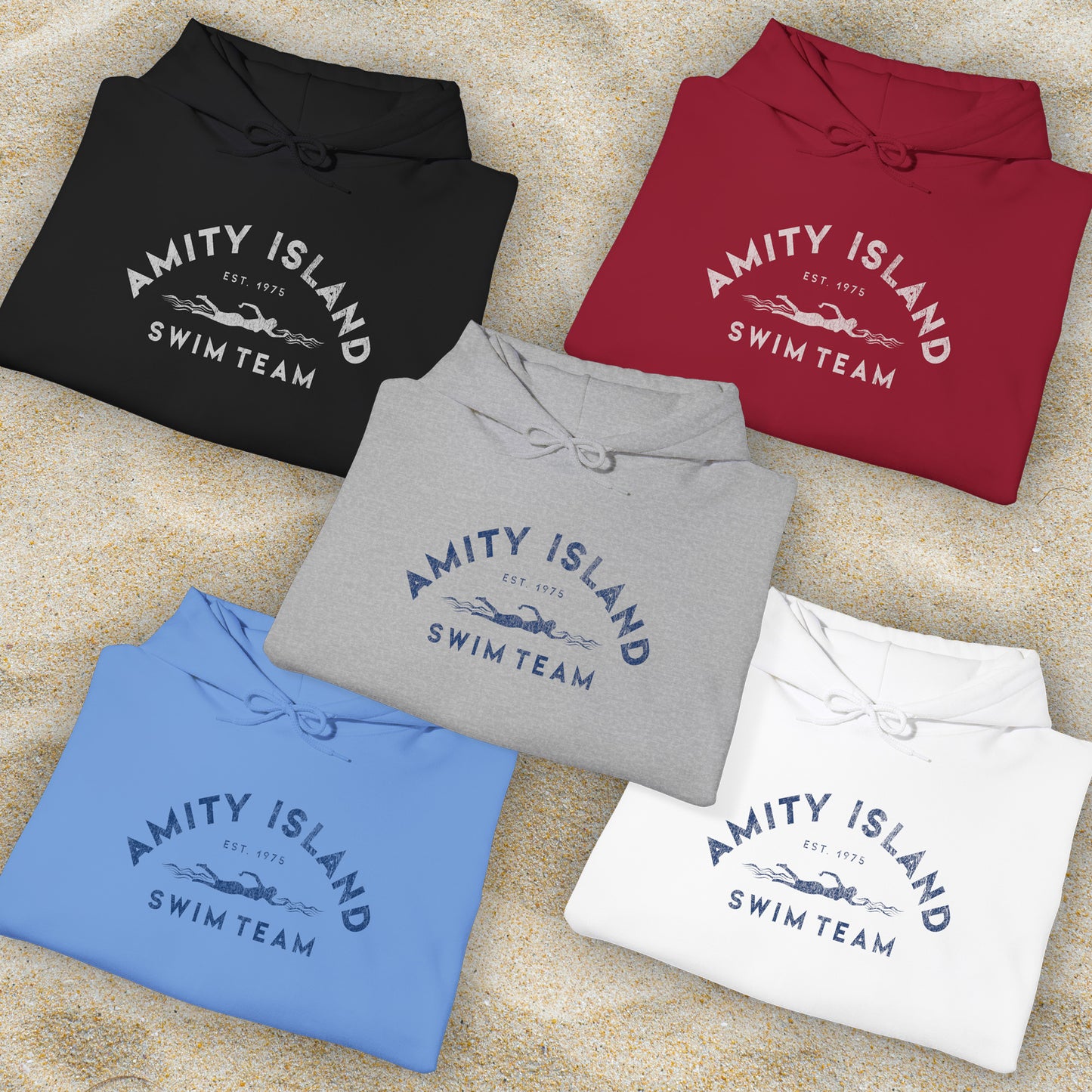 Group of 5 folded Soft Unisex Hoodie Heavy Blend Hooded Sweatshirts featuring an Amity Island Swim Team logo graphic, designed by ScriptedBrand, and inspired by the movie Jaws in a vintage distressed style.