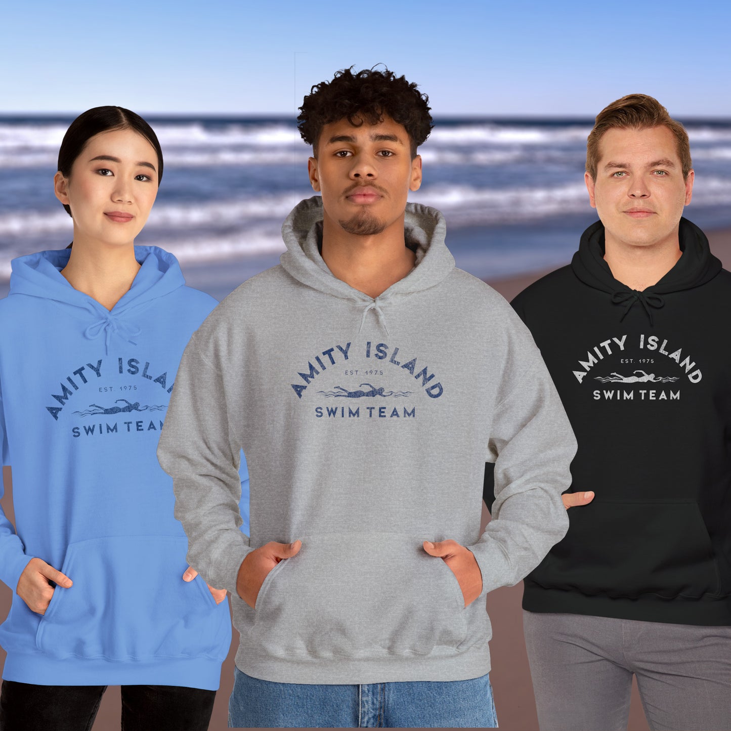 3 models wearing Soft Unisex Hoodie Heavy Blend Hooded Sweatshirts featuring an Amity Island Swim Team logo graphic, designed by ScriptedBrand, and inspired by the movie Jaws in a vintage distressed style.