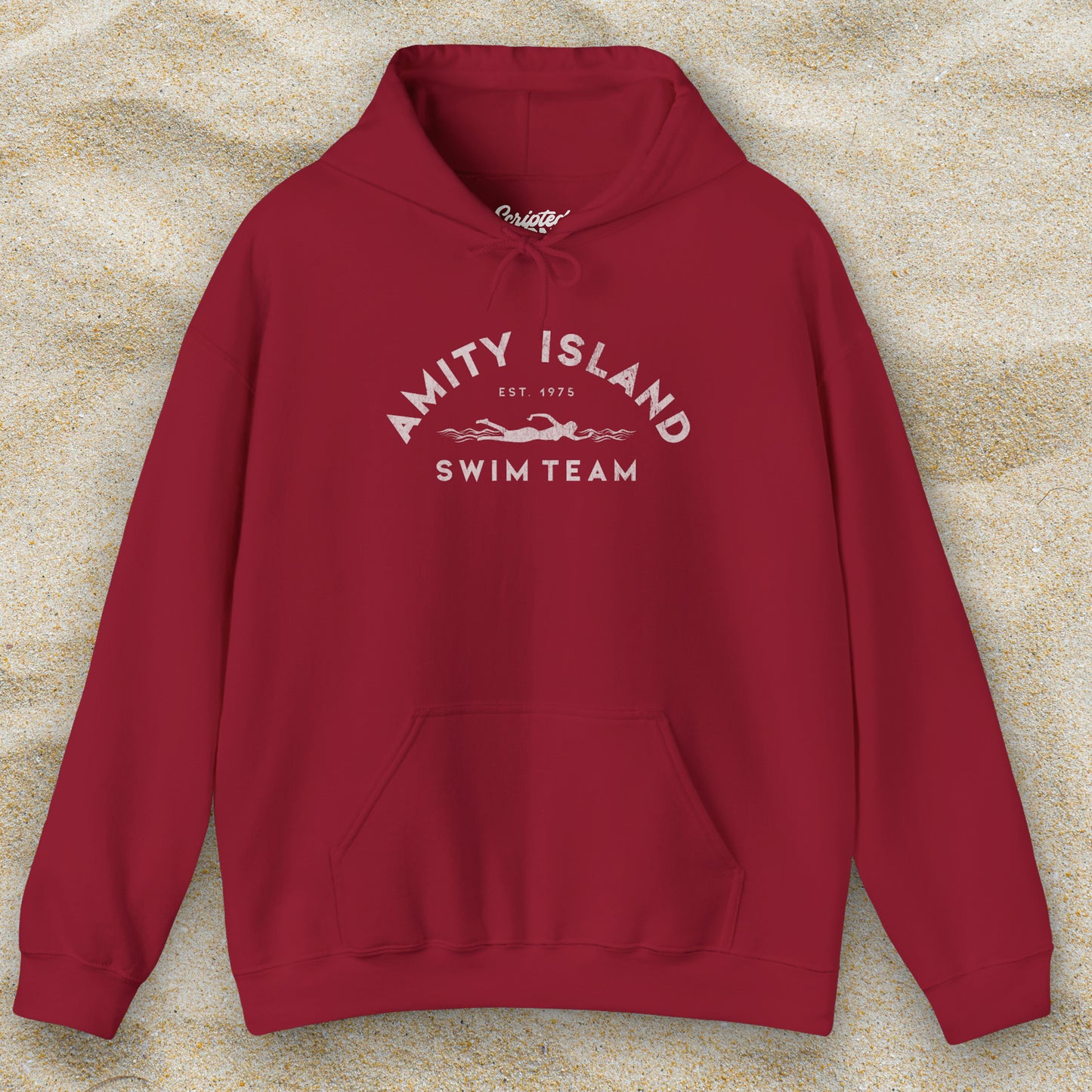 Front view of a cardinal red lifeguard colored Soft Unisex Hoodie Heavy Blend Hooded Sweatshirt featuring an Amity Island Swim Team logo graphic, designed by ScriptedBrand, and inspired by the movie Jaws in a vintage distressed style.