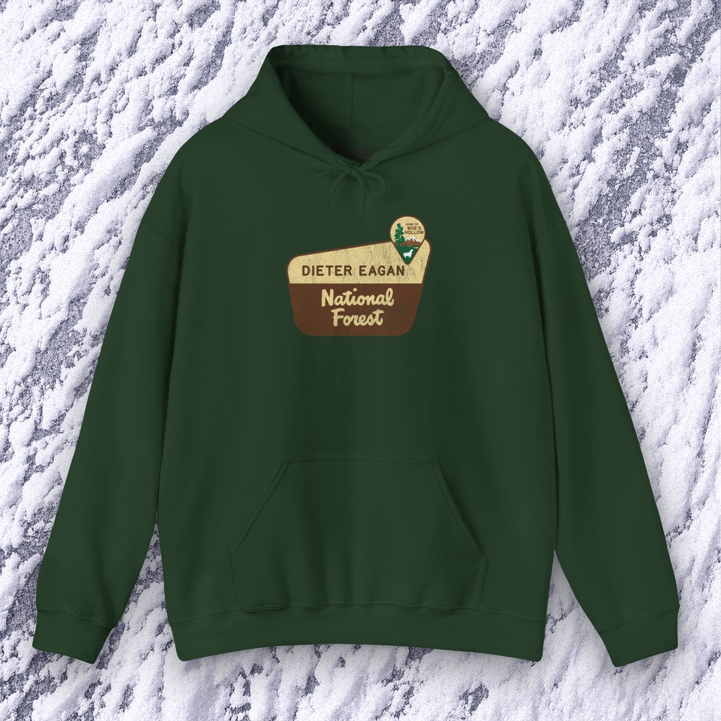 Mockup of a Forest green colored Soft Unisex Hoodie Heavy Blend Hooded Sweatshirt featuring the logo graphic of the Dieter Eagan National Forest inspired by the TV show Severance in a vintage distressed ink-stamped worn-in style.