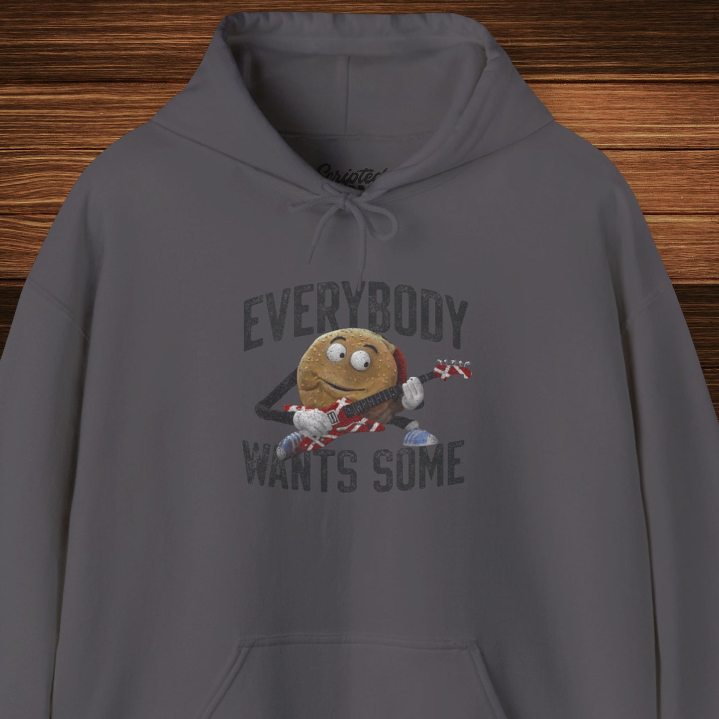Front view of a charcoal grey colored soft Unisex Hoodie Heavy Blend Hooded Sweatshirt featuring the phrase EVERYBODY WANTS SOME with a graphic of the Van Halen singing hamburger playing guitar from the movie Better Off Dead, designed by ScriptedBrand in a vintage distressed style.