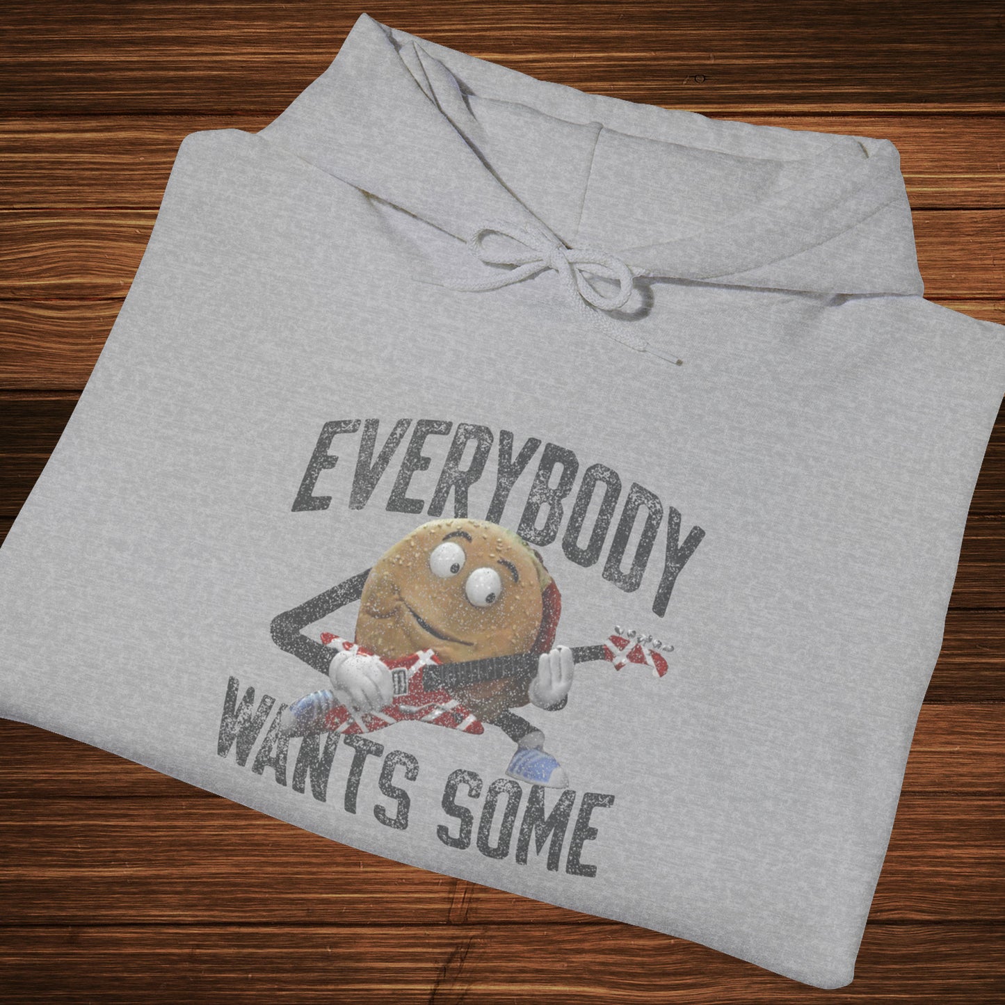 Folded sport athletic grey colored soft Unisex Hoodie Heavy Blend Hooded Sweatshirt featuring the phrase EVERYBODY WANTS SOME with a graphic of the Van Halen singing hamburger playing guitar from the movie Better Off Dead, designed by ScriptedBrand in a vintage distressed style.