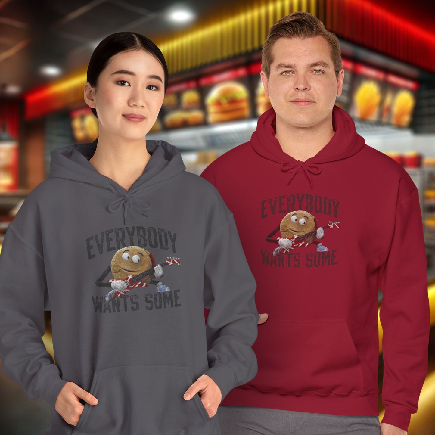 2 models wearing soft Unisex Hoodie Heavy Blend Hooded Sweatshirts featuring the phrase EVERYBODY WANTS SOME with a graphic of the Van Halen singing hamburger playing guitar from the movie Better Off Dead, designed by ScriptedBrand in a vintage distressed style.