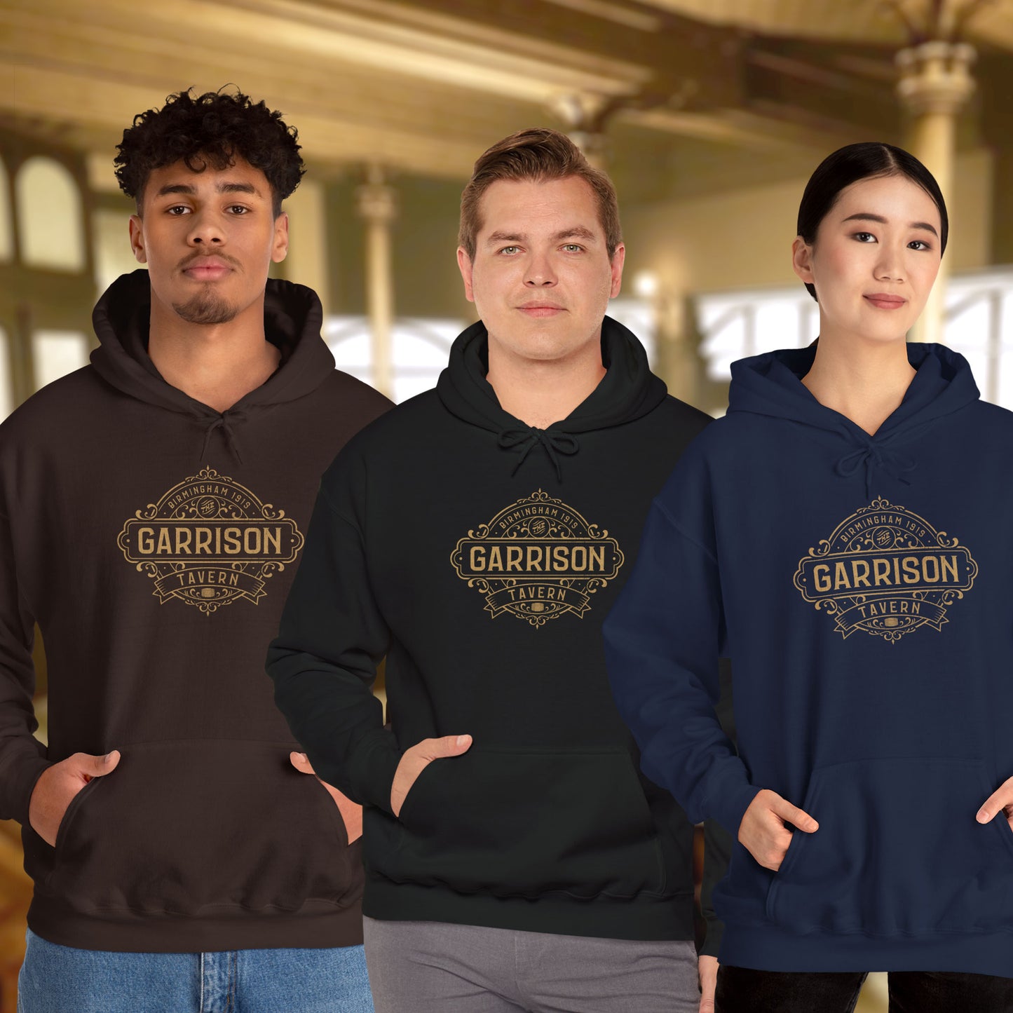 3 models wearing Soft Unisex Hoodie Heavy Blend Hooded Sweatshirts featuring the Garrison Tavern Bar Logo Graphic inspired by the TV show and movie Peaky Blinders in a vintage distressed style sold by ScriptedBrand.