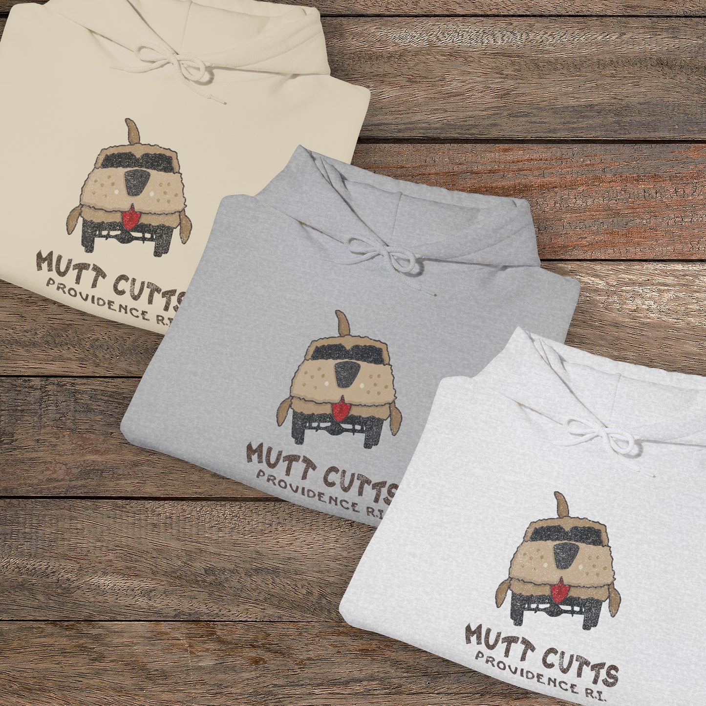 Group of 3 folded soft Unisex Hoodie Heavy Blend Hooded Sweatshirts featuring a Mutt Cutts logo graphic inspired by the movie Dumb and Dumber, illustrated by ScriptedBrand in a vintage distressed style.