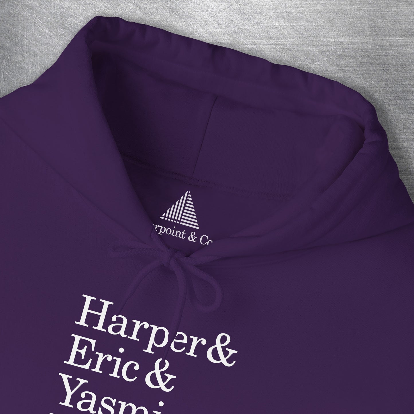 Closeup of neck tag on Purple hoodie with names Harper, Eric, Yasmin, Robert & Rishi in Pierpoint & Co. font, inspired by TV show Industry.