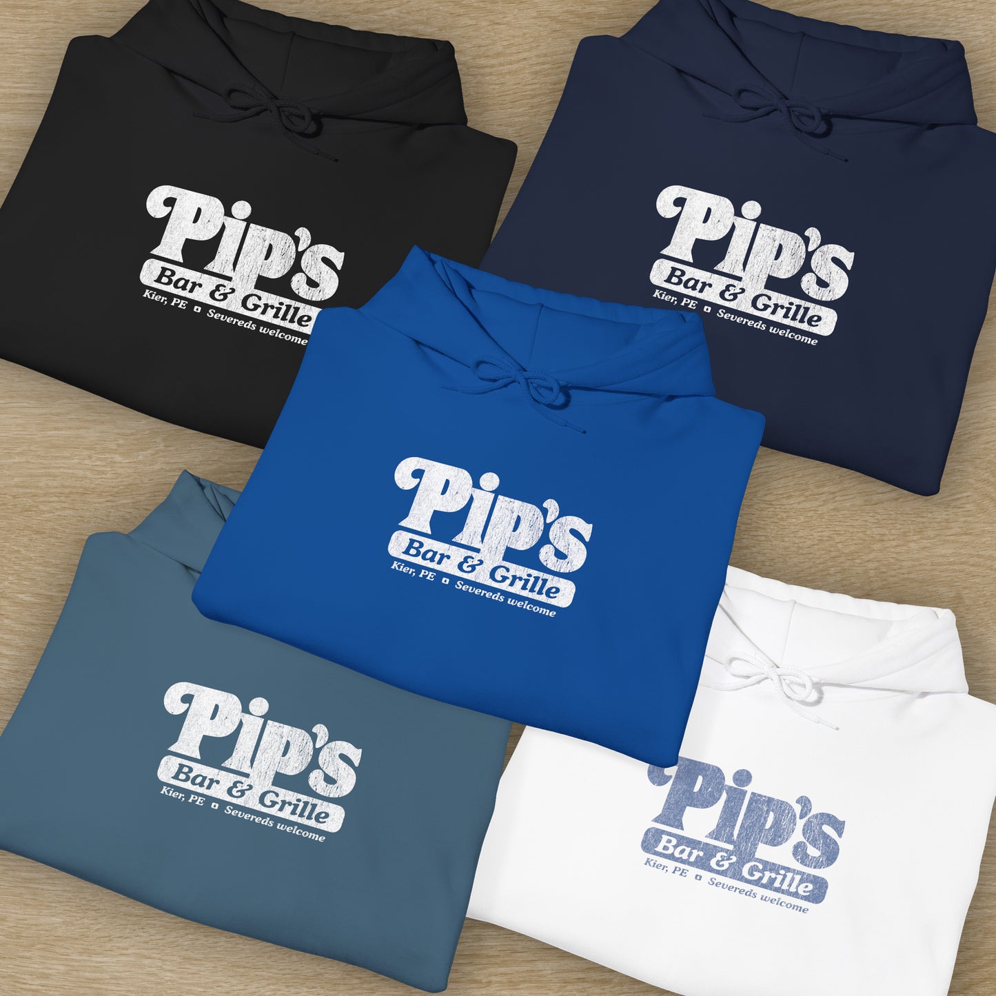 Group of 5 folded Soft Unisex Hoodie Heavy Blend Hooded Sweatshirts featuring the Pips Bar & Grill logo, with the added text "Severeds Welcome" inspired by the TV show Severance in a vintage distressed style, sold by ScriptedBrand.
