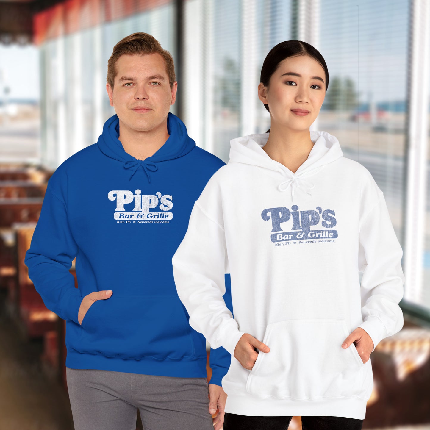 2 models wearing Soft Unisex Hoodie Heavy Blend Hooded Sweatshirts featuring the Pips Bar & Grill logo, with the added text "Severeds Welcome" inspired by the TV show Severance in a vintage distressed style, sold by ScriptedBrand.