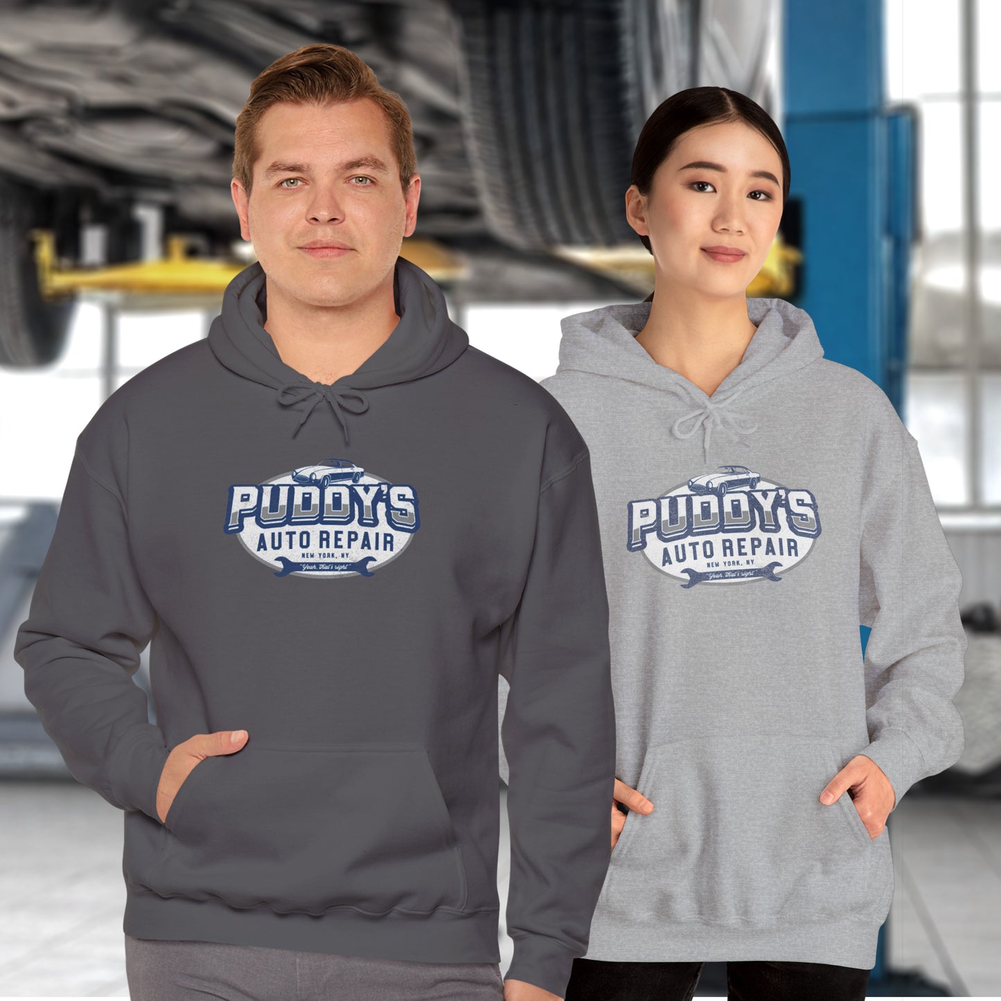 2 models wearing soft Unisex Hoodie Heavy Blend Hooded Sweatshirts featuring a Puddy's Auto Repair graphic designed by ScriptedBrand inspired by the TV show Seinfeld in a vintage distressed style.