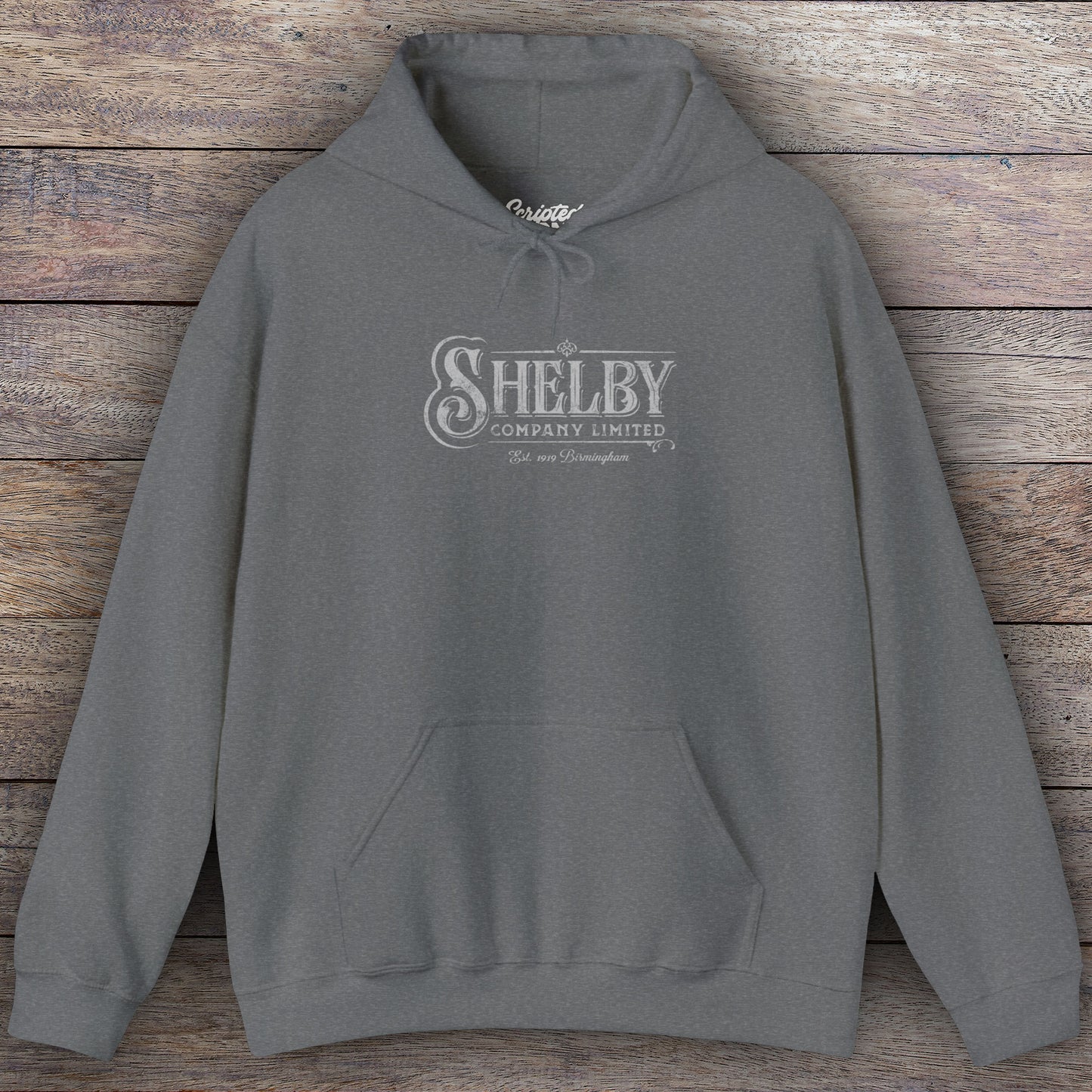 Dark heather gray colored Soft Unisex Hoodie Heavy Blend Hooded Sweatshirt featuring the fictional logo Shelby Company Limited from the TV series Peaky Blinders in a vintage distressed style.