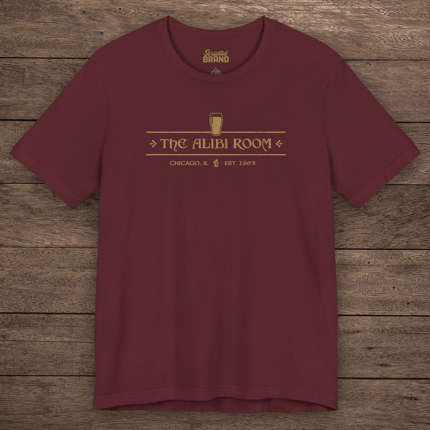 Maroon t-shirt featuring The Alibi Room logo graphic inspired by the TV show Shameless in a vintage distressed style.