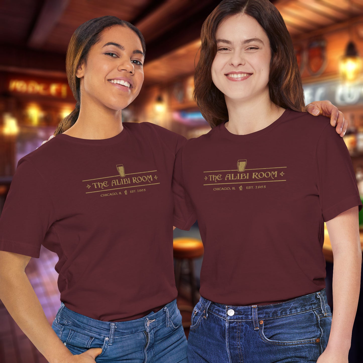 2 women wearing maroon t-shirts featuring The Alibi Room logo graphic inspired by the TV show Shameless in a vintage distressed style.