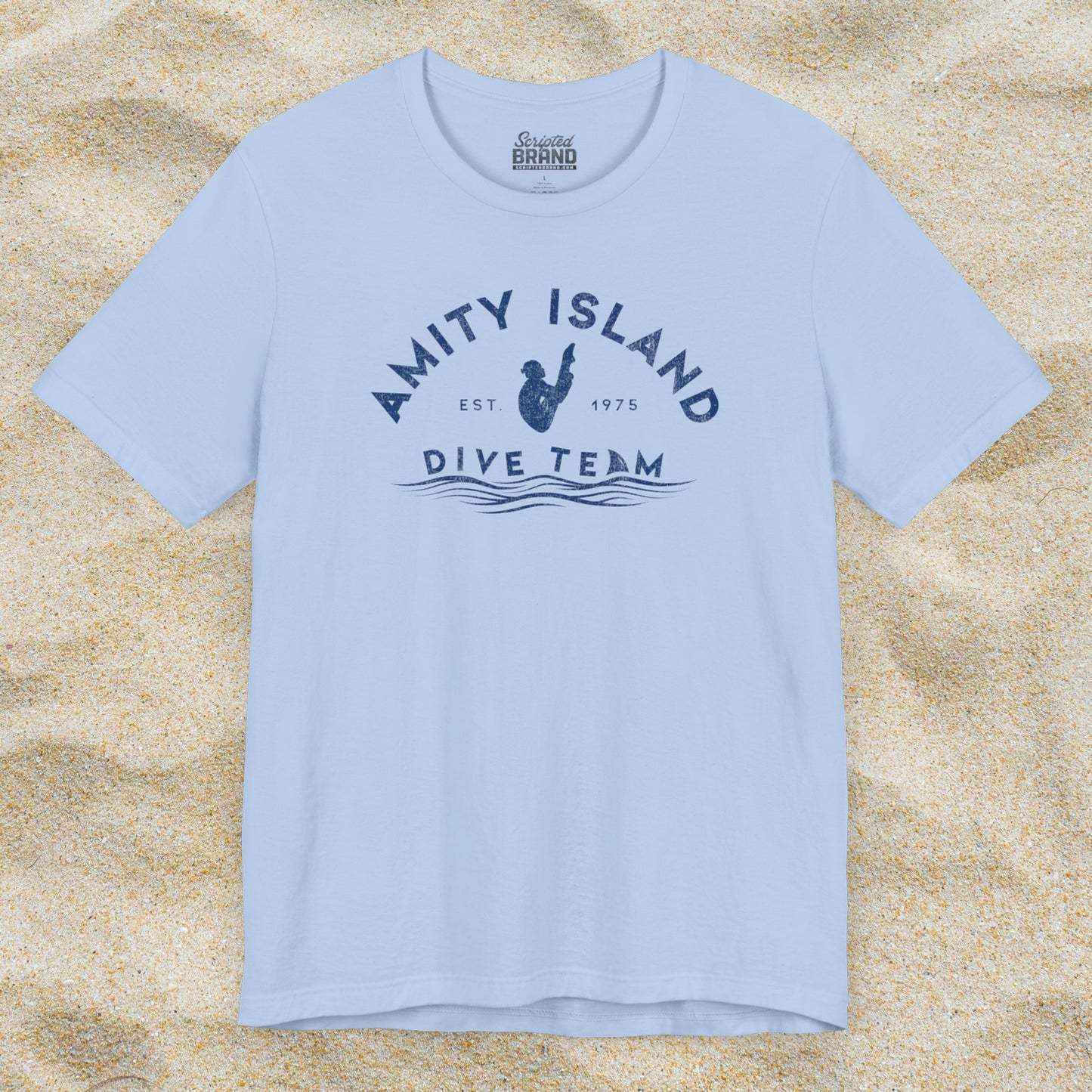 Front view of Baby Blue Bella+Canvas t-shirt with vintage-style Amity Island Dive Team logo, inspired by the movie Jaws.