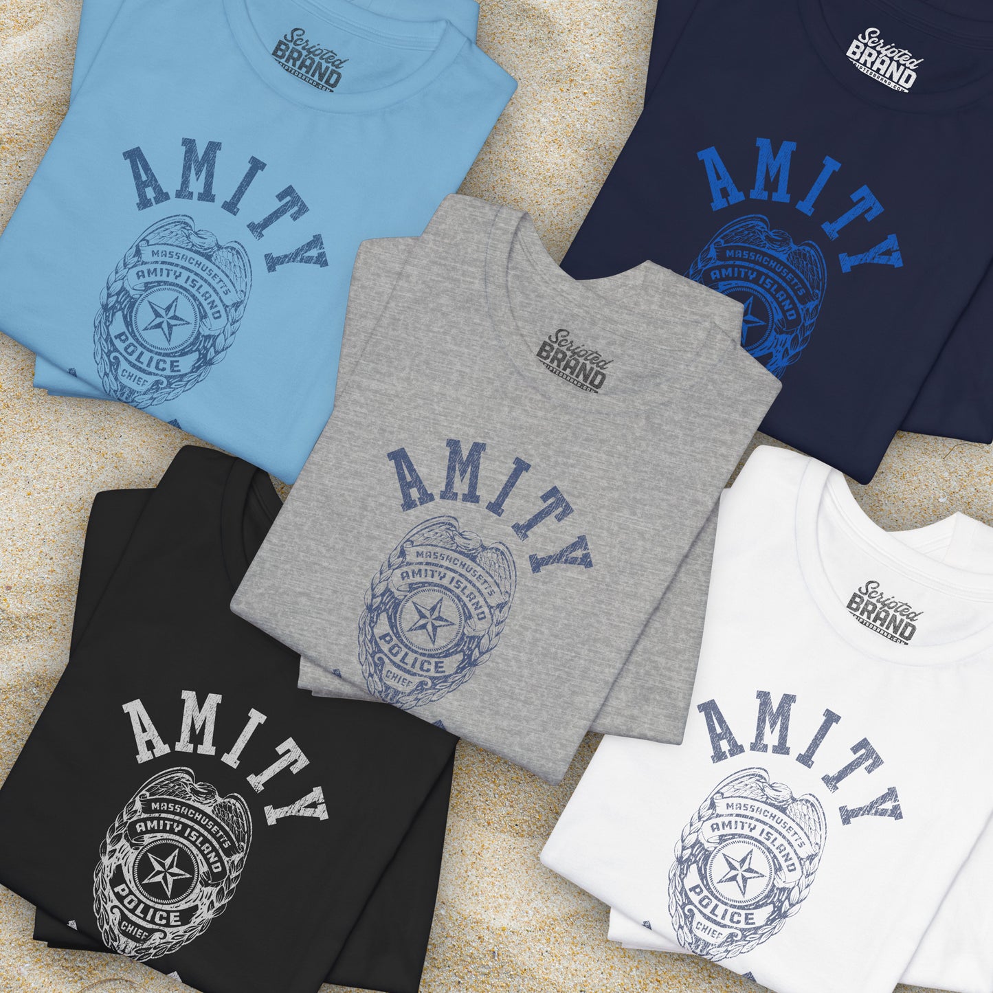Group of 5 folded Soft unisex Bella+Canvas 3001 short-sleeve t-shirt featuring an Amity Island Police logo graphic, designed by ScriptedBrand, and inspired by the movie Jaws in a vintage distressed style.