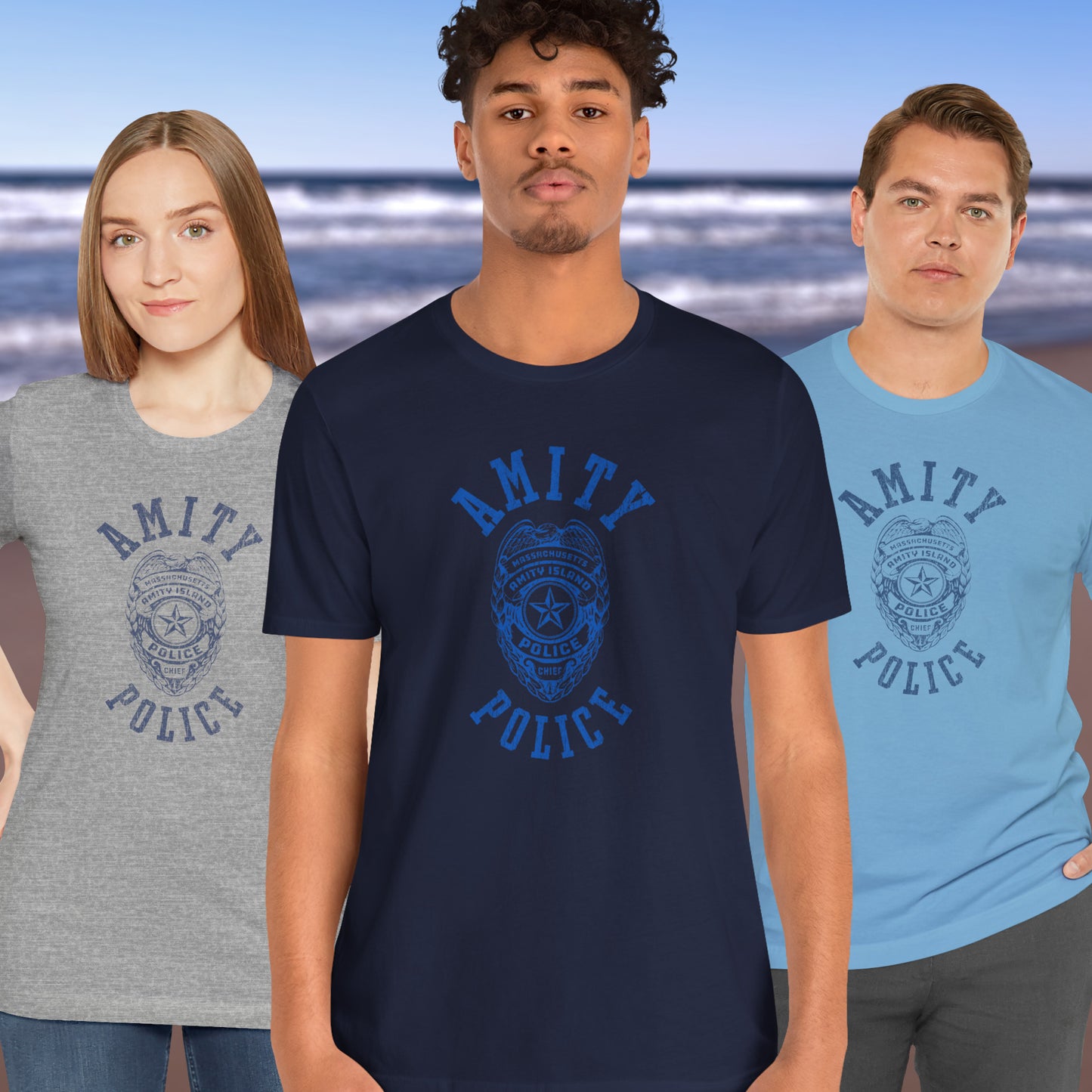 3 models wearing Soft unisex Bella+Canvas 3001 short-sleeve t-shirts featuring an Amity Island Police logo graphic, designed by ScriptedBrand, and inspired by the movie Jaws in a vintage distressed style.