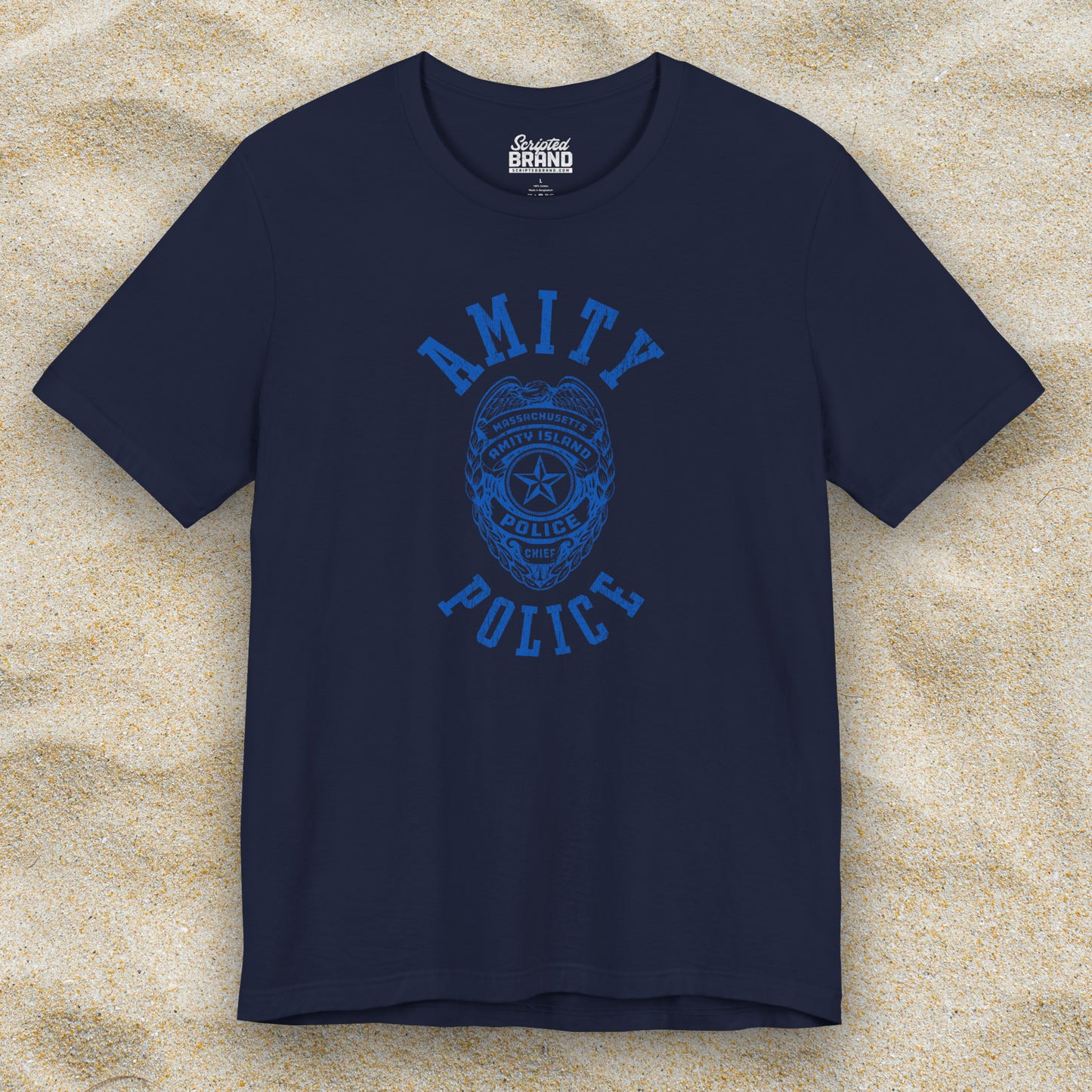 Front view of a navy blue colored Soft unisex Bella+Canvas 3001 short-sleeve t-shirt featuring an Amity Island Police logo graphic, designed by ScriptedBrand, and inspired by the movie Jaws in a vintage distressed style.
